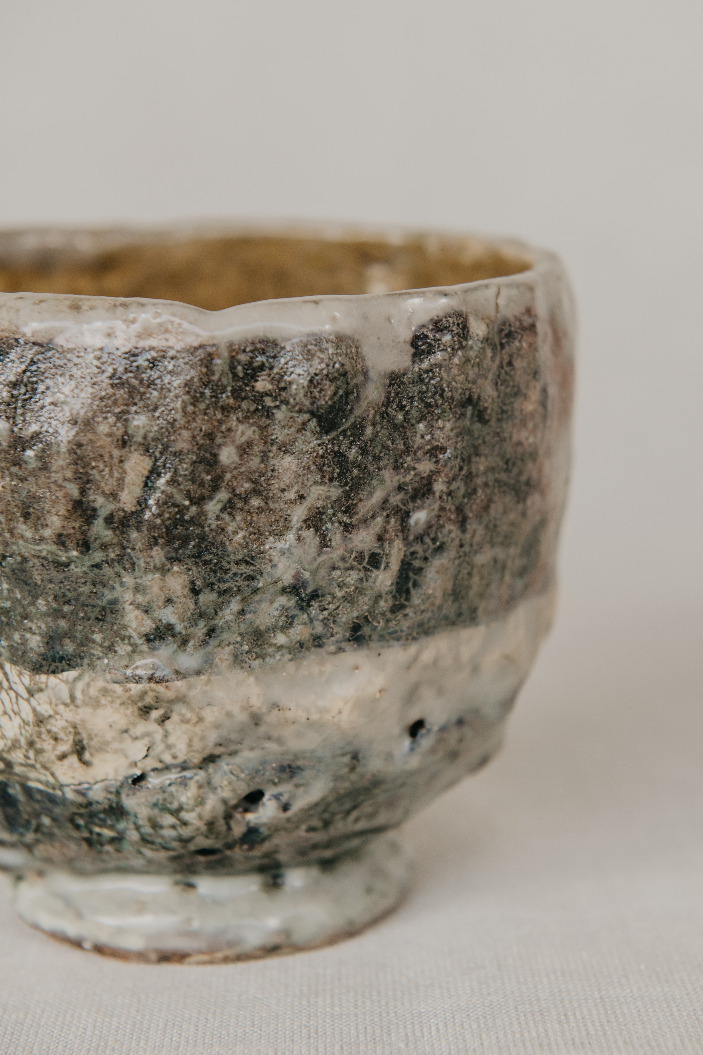 Vintage ceramic bowl with a textured surface on a neutral background