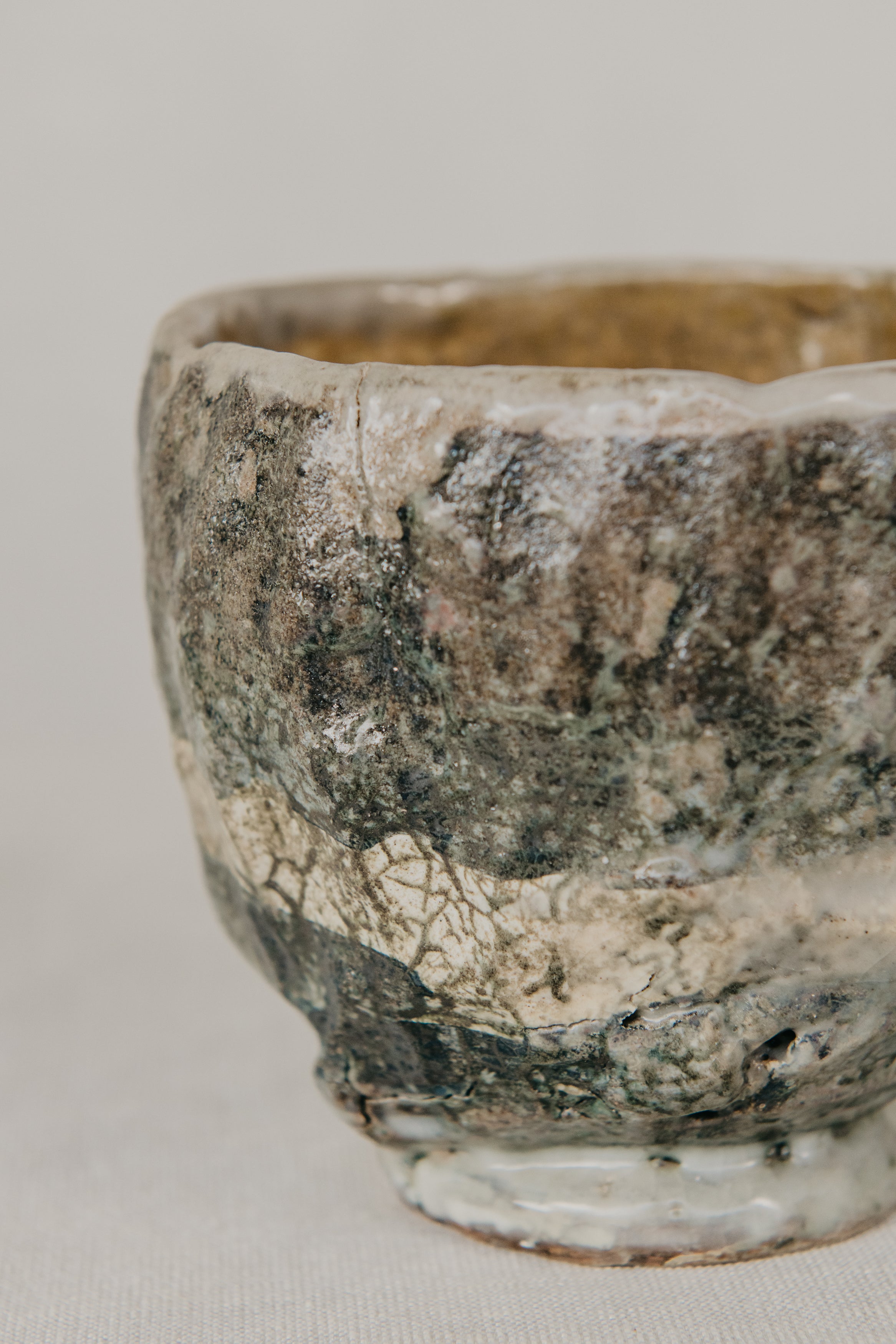 Vintage ceramic bowl with a textured surface on a light gray background