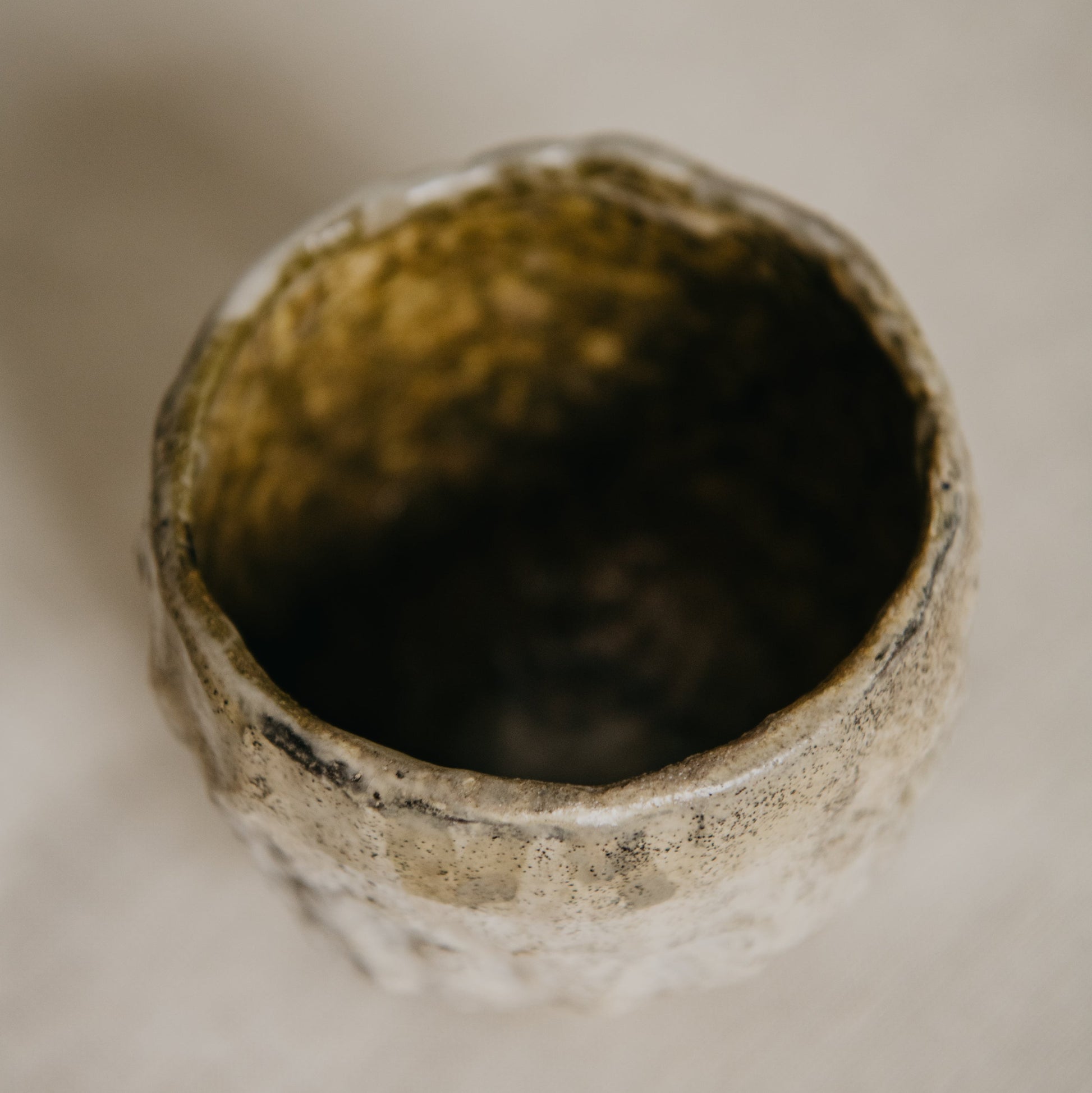 Close-up of a textured ceramic bowl on a neutral background
