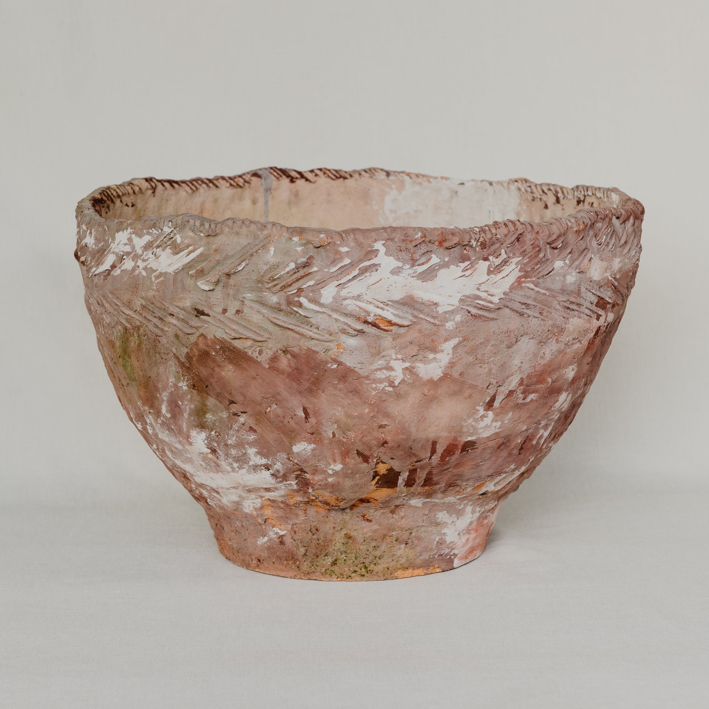 Vintage glass bowl with textured surface on a plain background