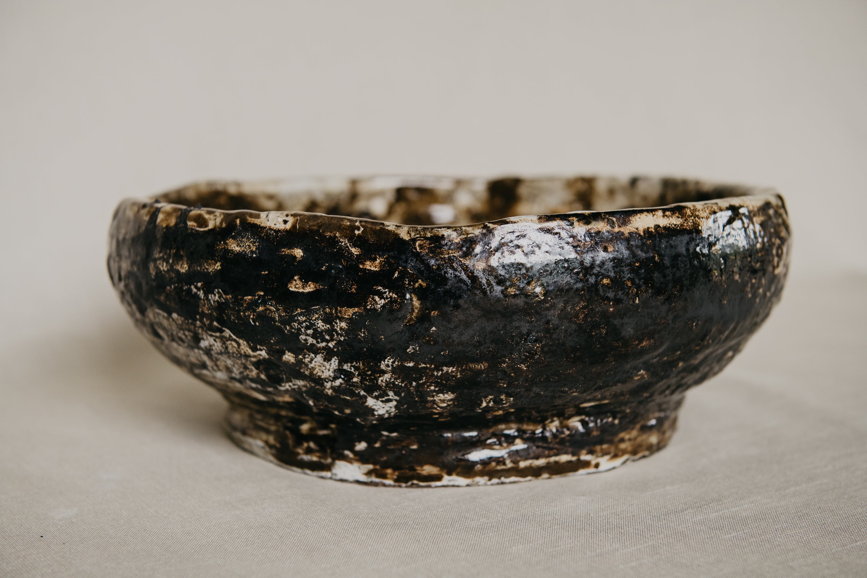 Brown ceramic bowl with a textured surface on a neutral background