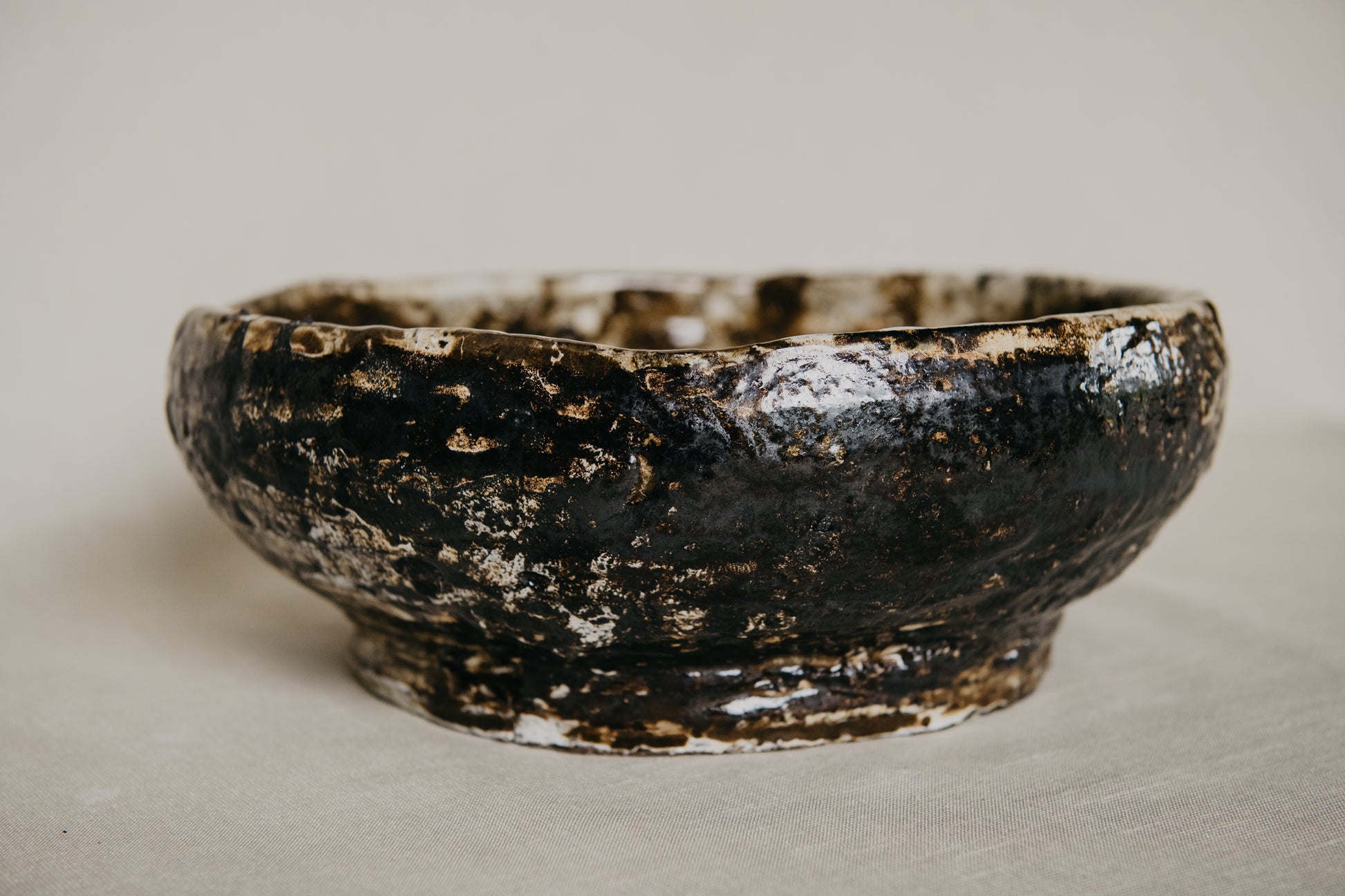 Brown ceramic bowl with a textured surface on a neutral background