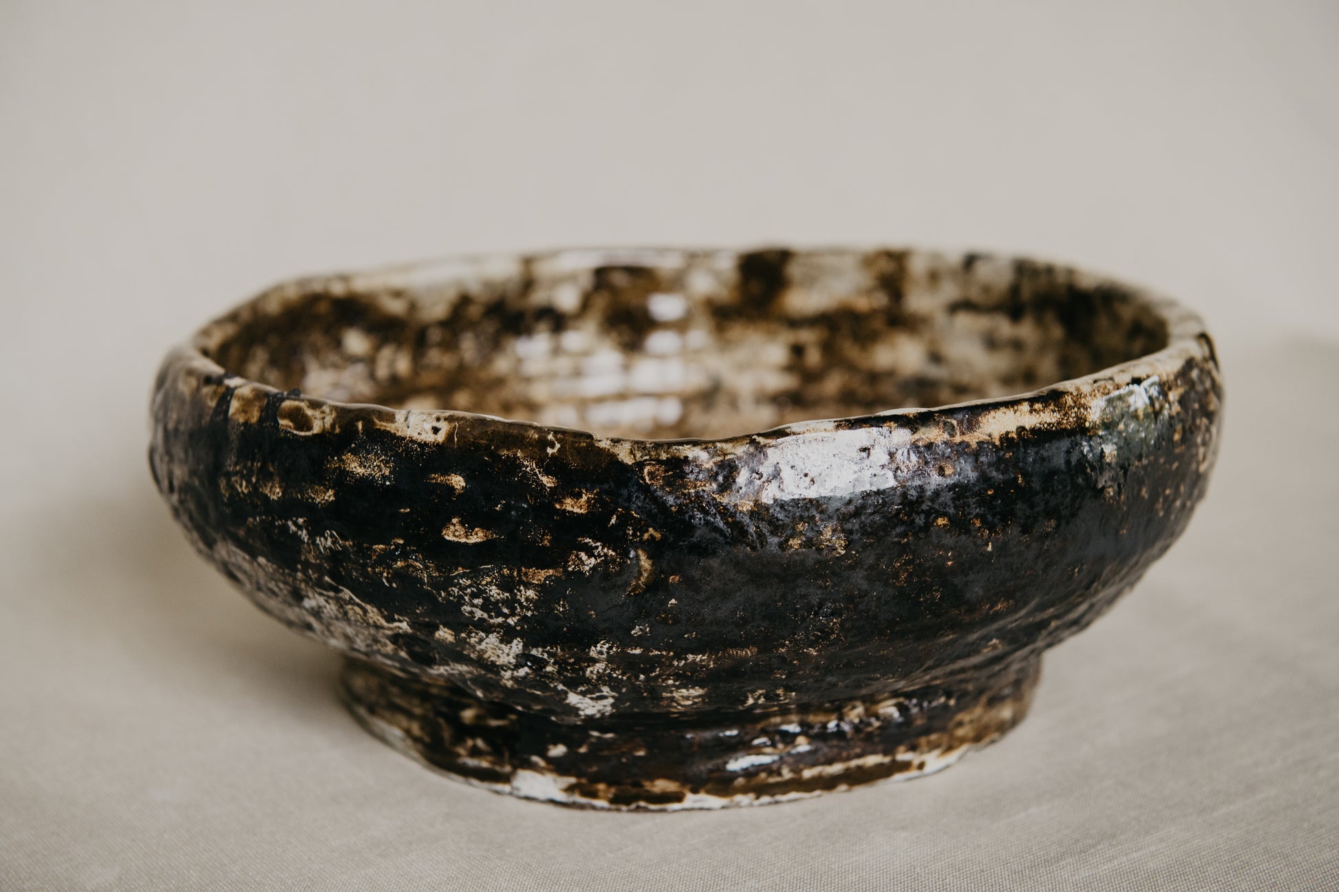 Brown ceramic bowl with a textured surface on a neutral background