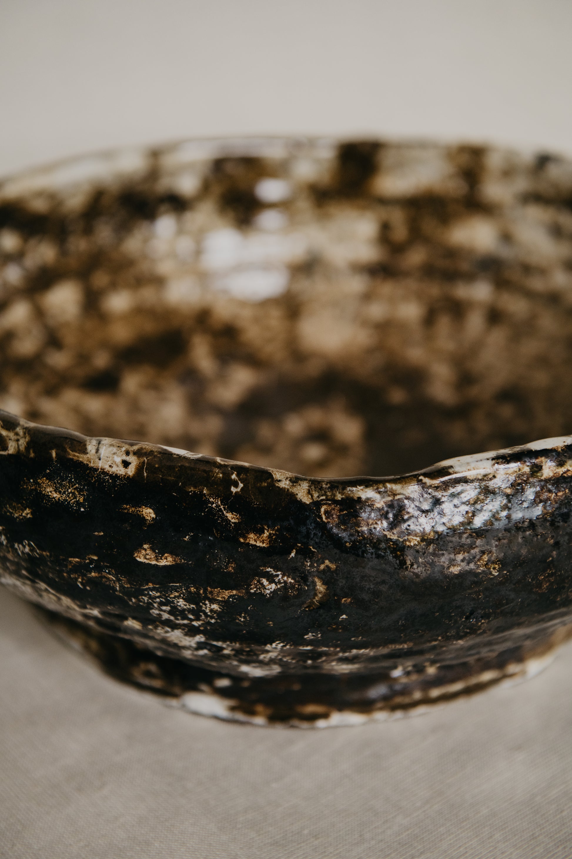 Close-up of a textured ceramic bowl on a neutral background