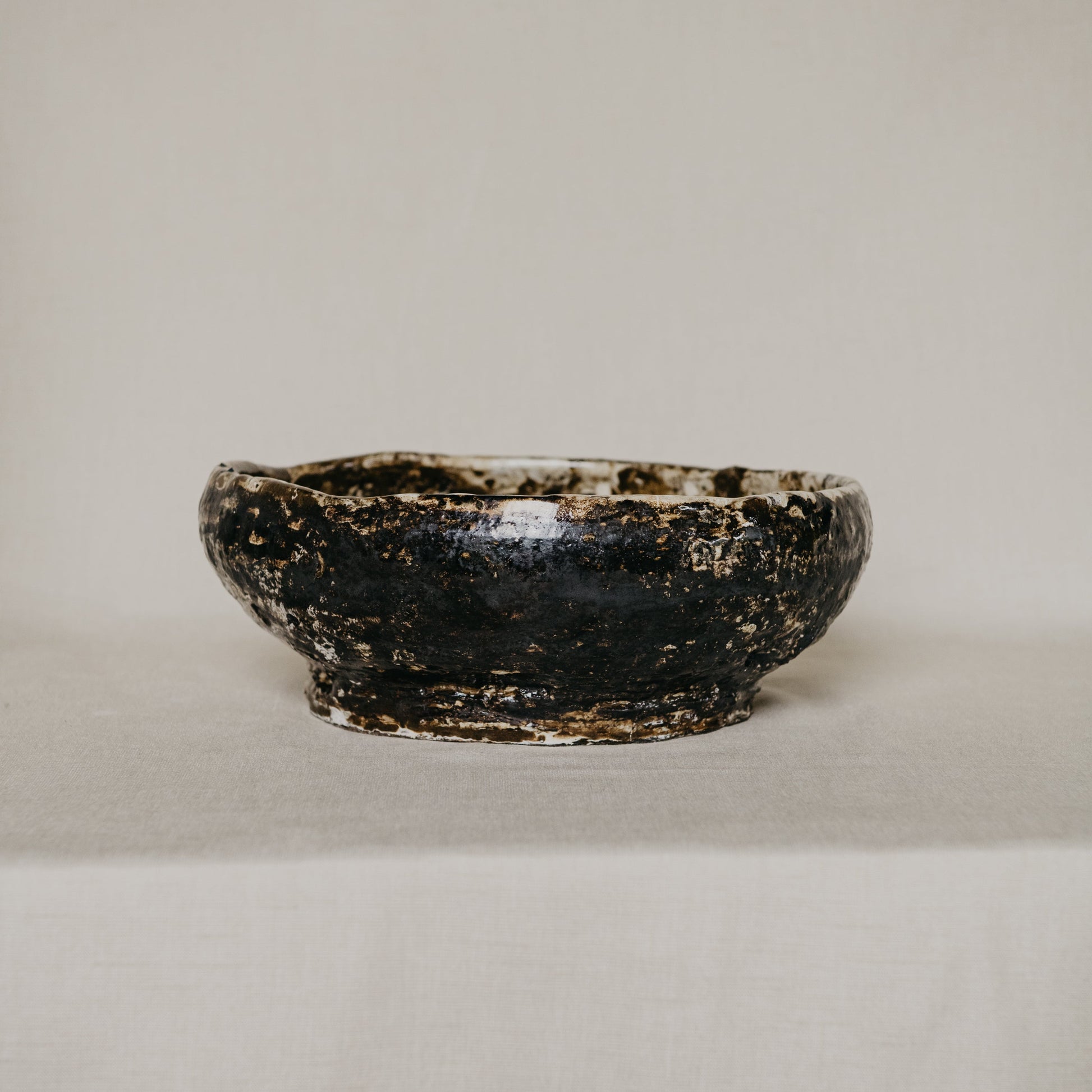 Brown ceramic bowl on a light gray background