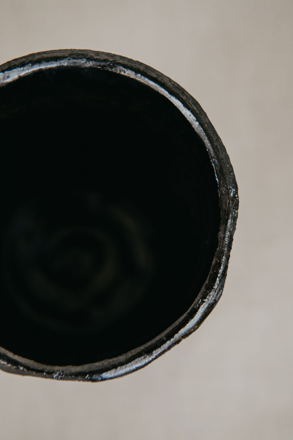 Close-up of a black metal pipe on a beige background