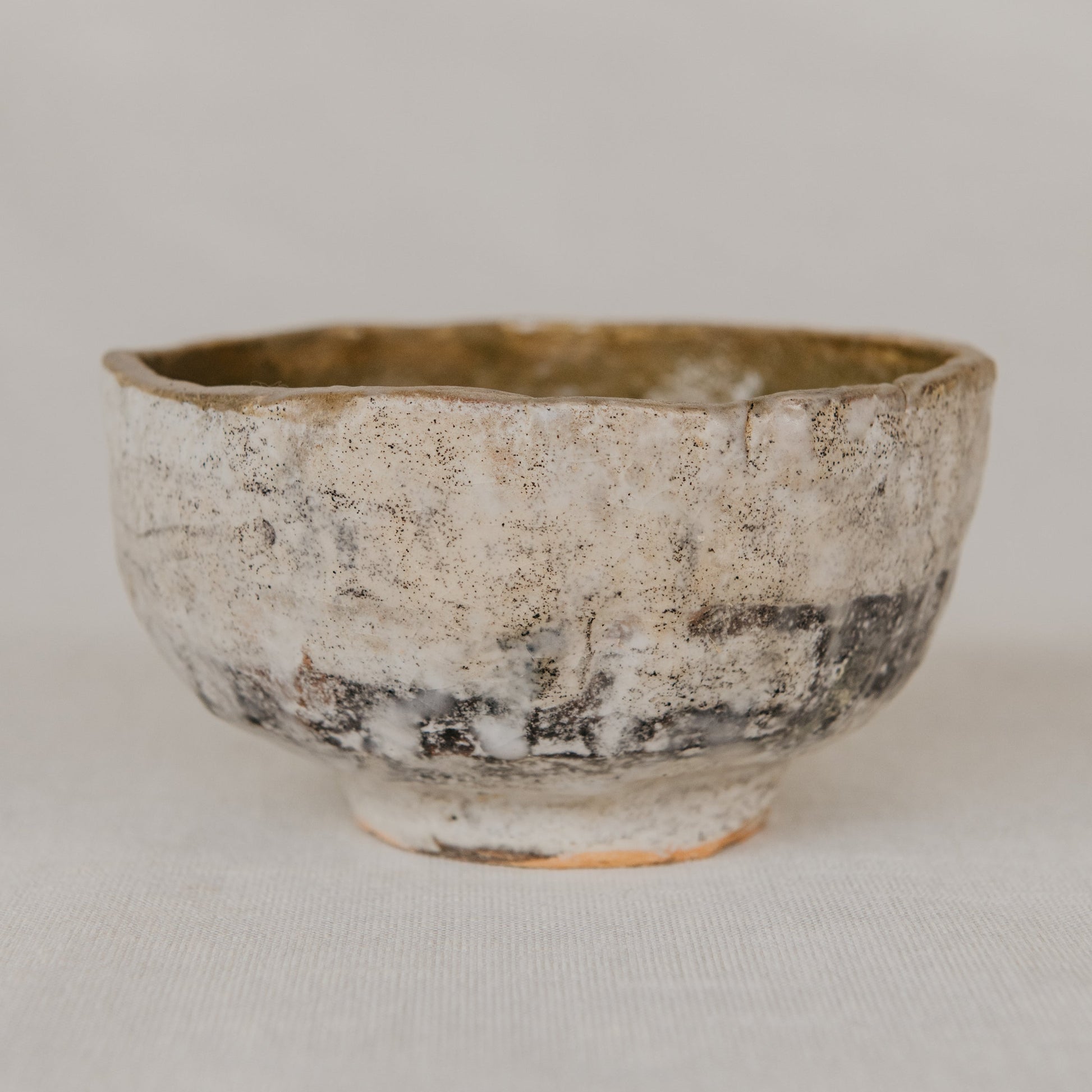 Small ceramic bowl with a textured surface on a plain background