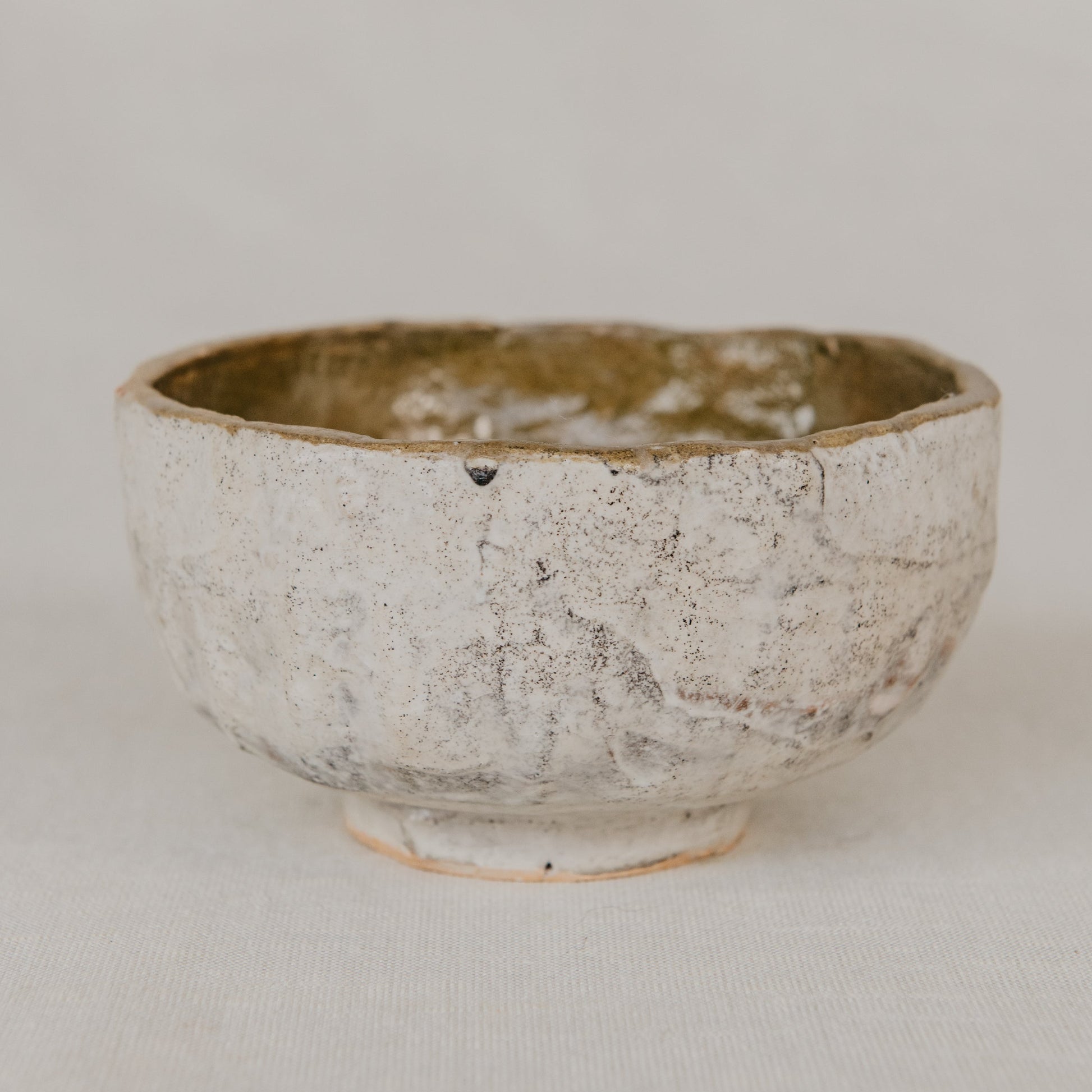 Ceramic bowl with textured surface on a plain background