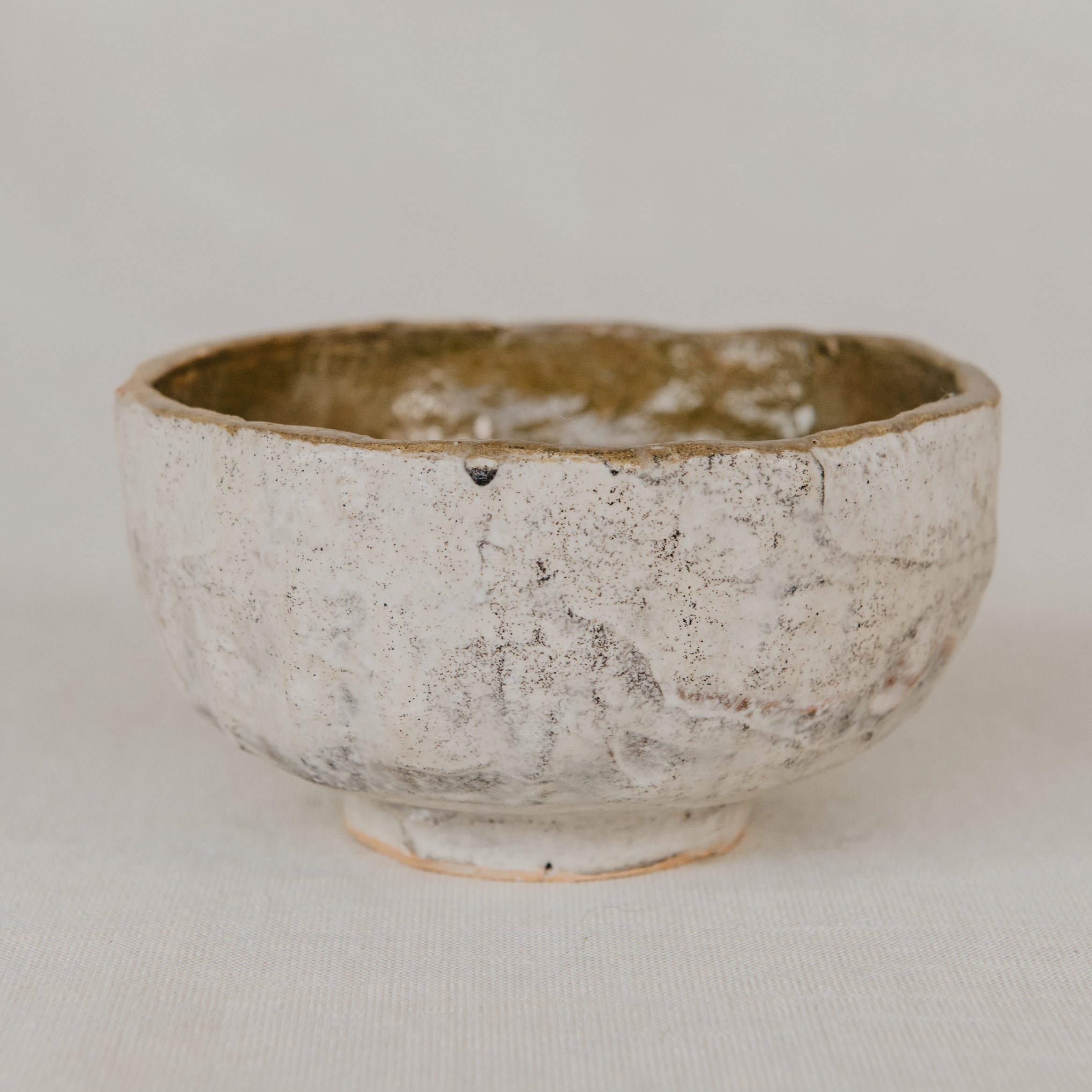 Ceramic bowl with textured surface on a plain background