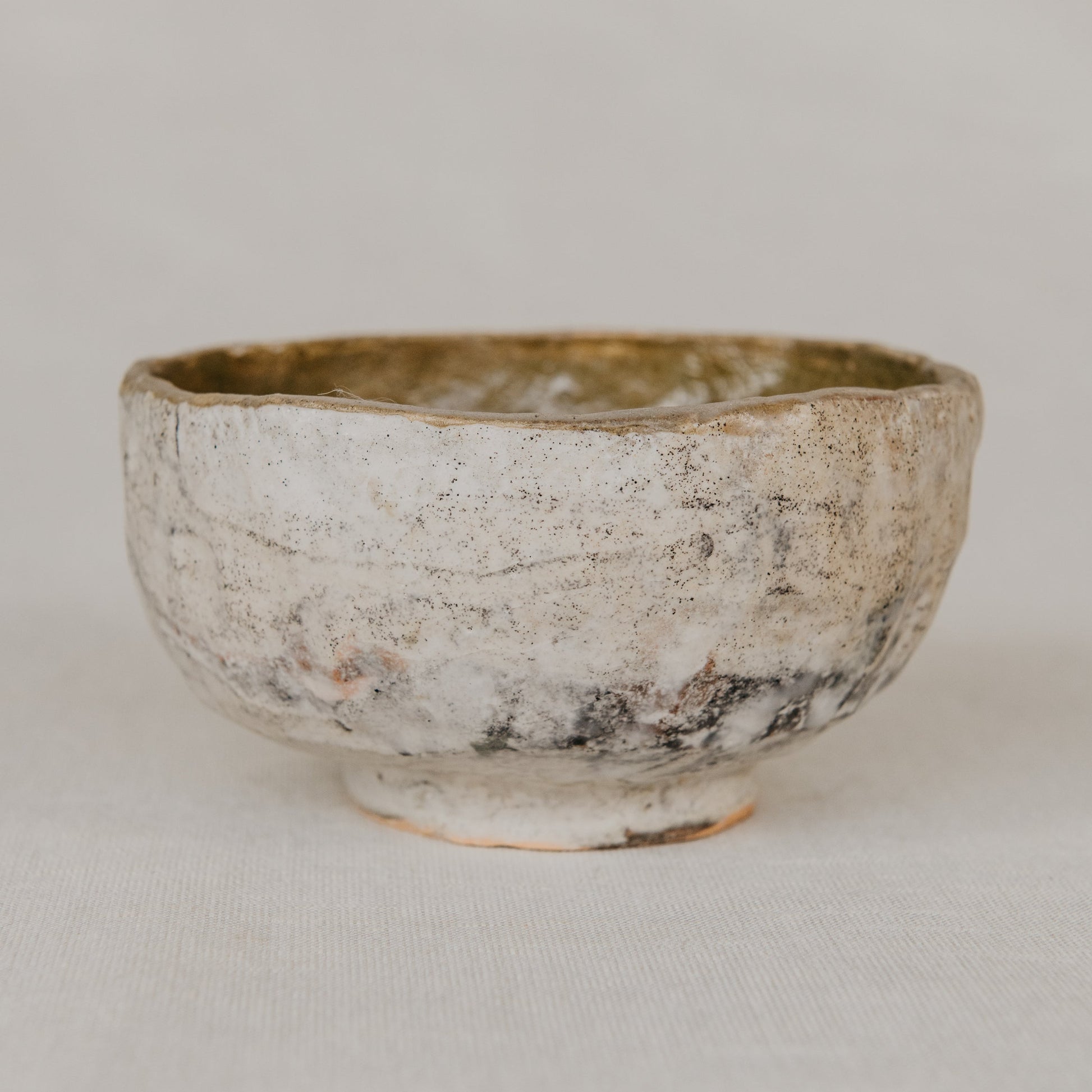 Small ceramic bowl with a textured surface on a plain background
