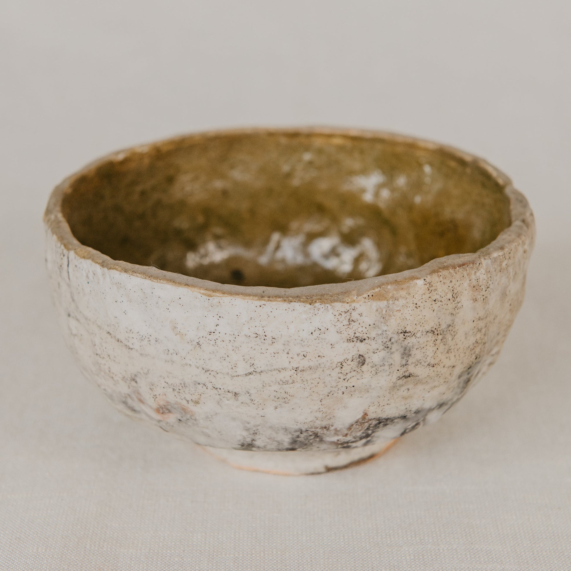 Ceramic bowl with a textured surface on a neutral background