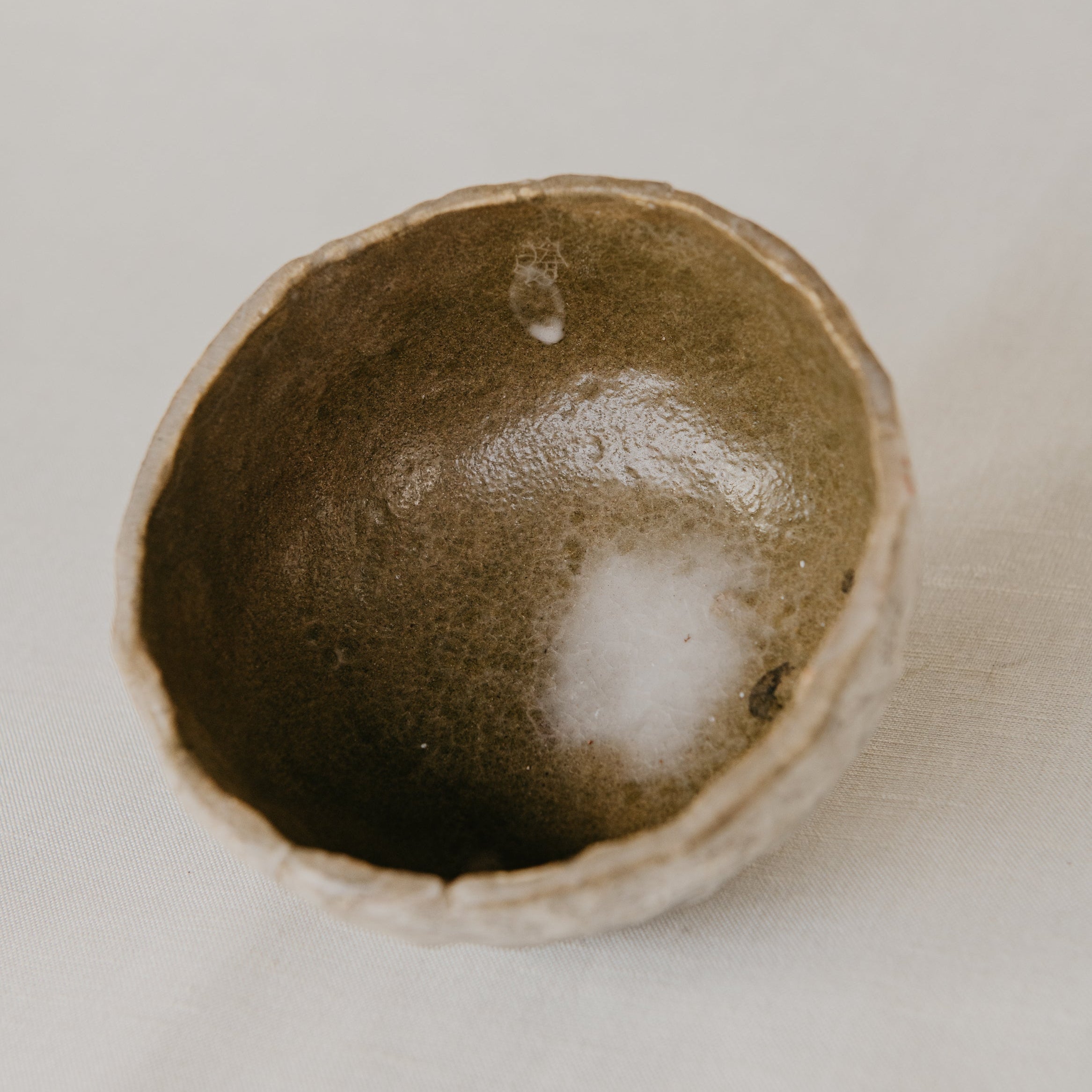 Small ceramic bowl with a textured surface on a light background
