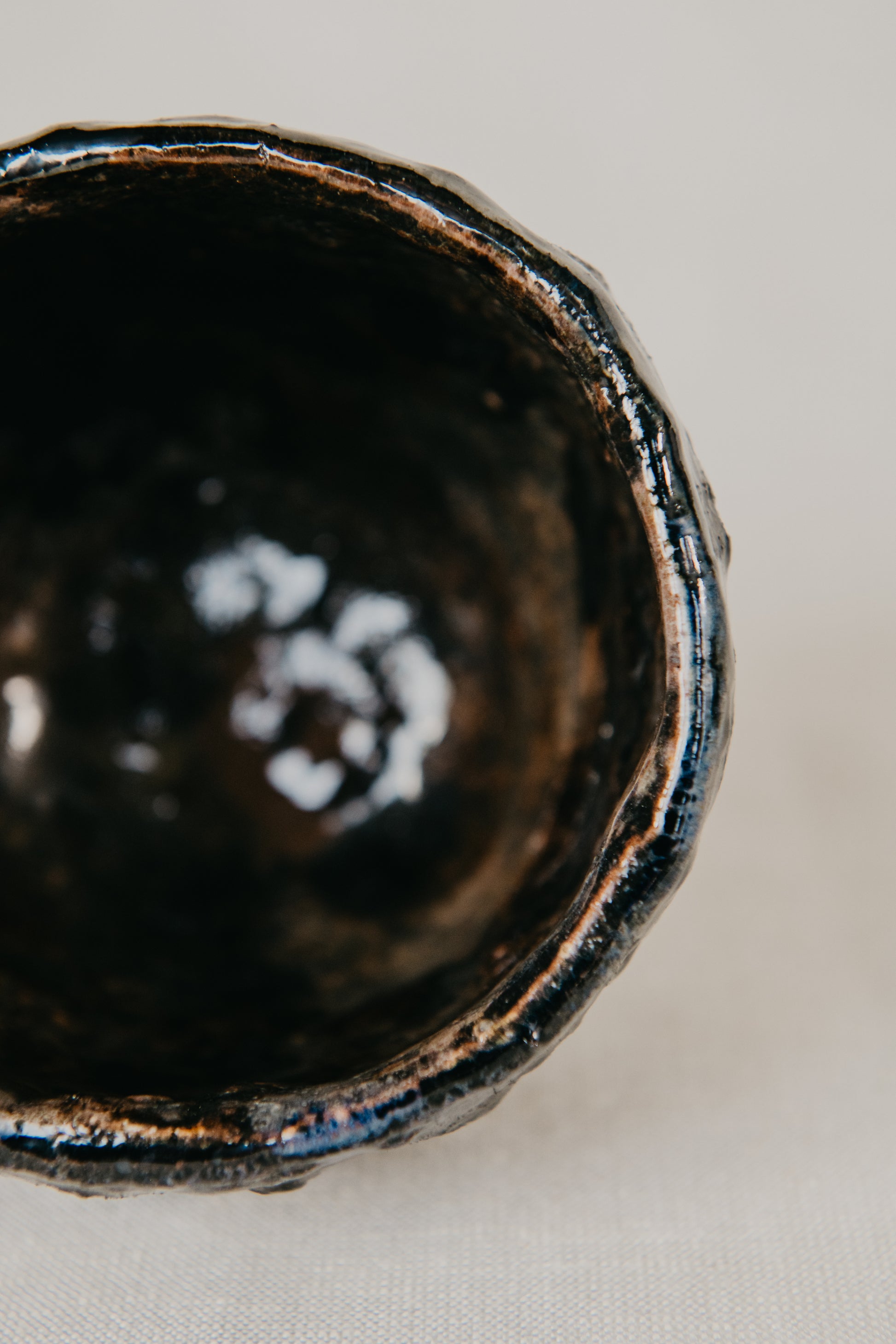 Close-up of a black ceramic bowl on a light background