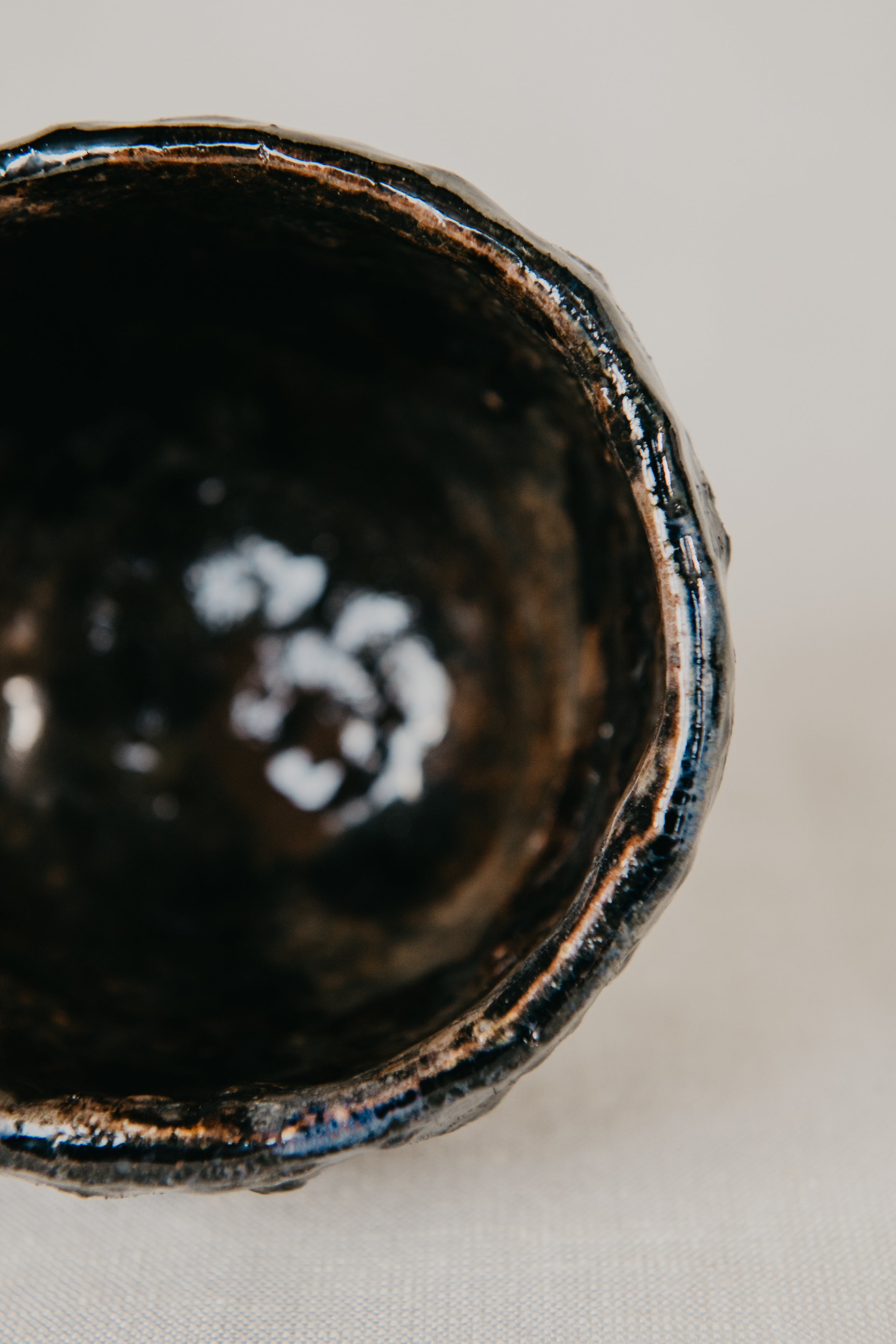 Close-up of a black ceramic bowl on a light background