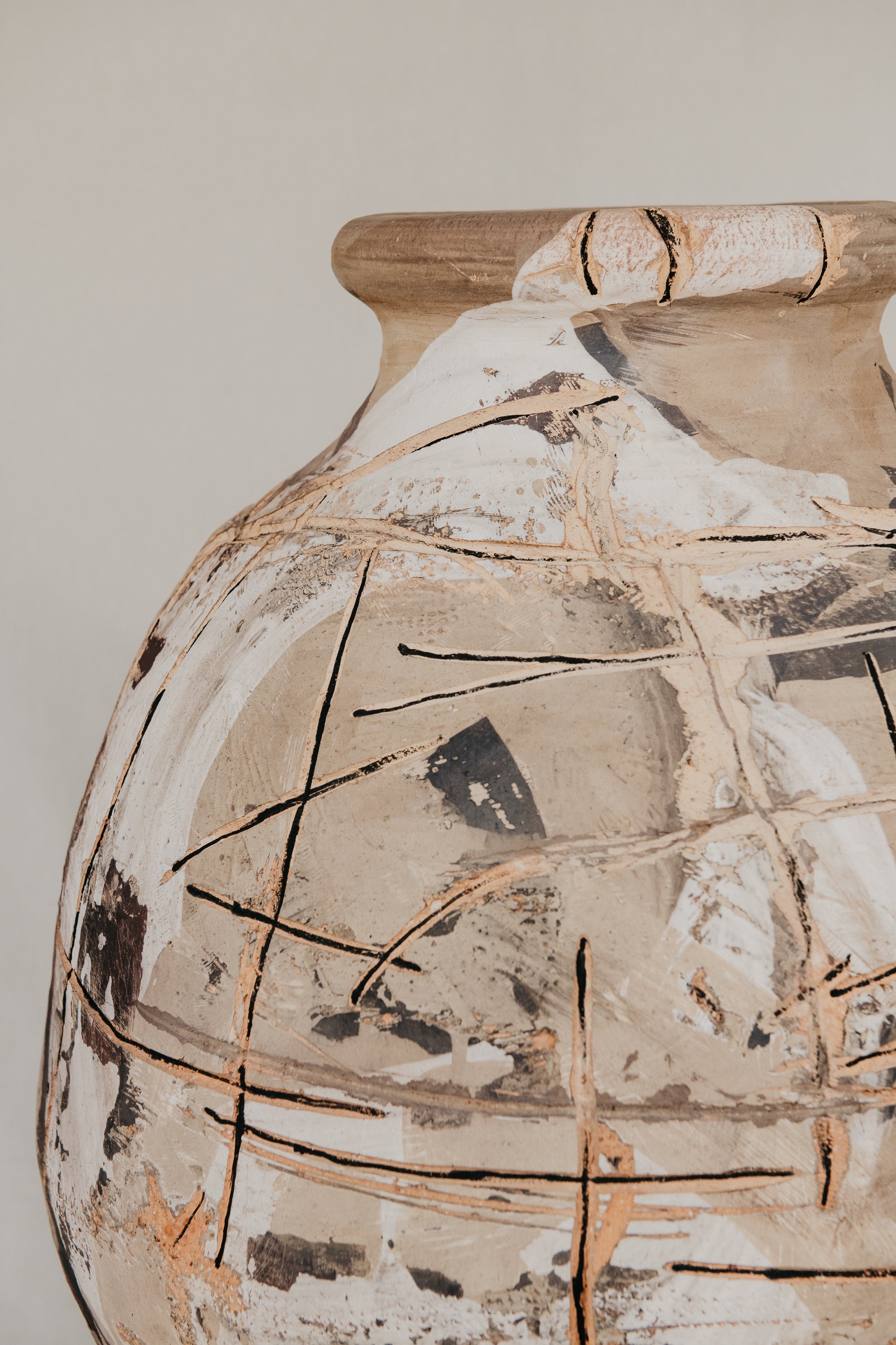 Vintage ceramic vase with decorative cracks on a plain background