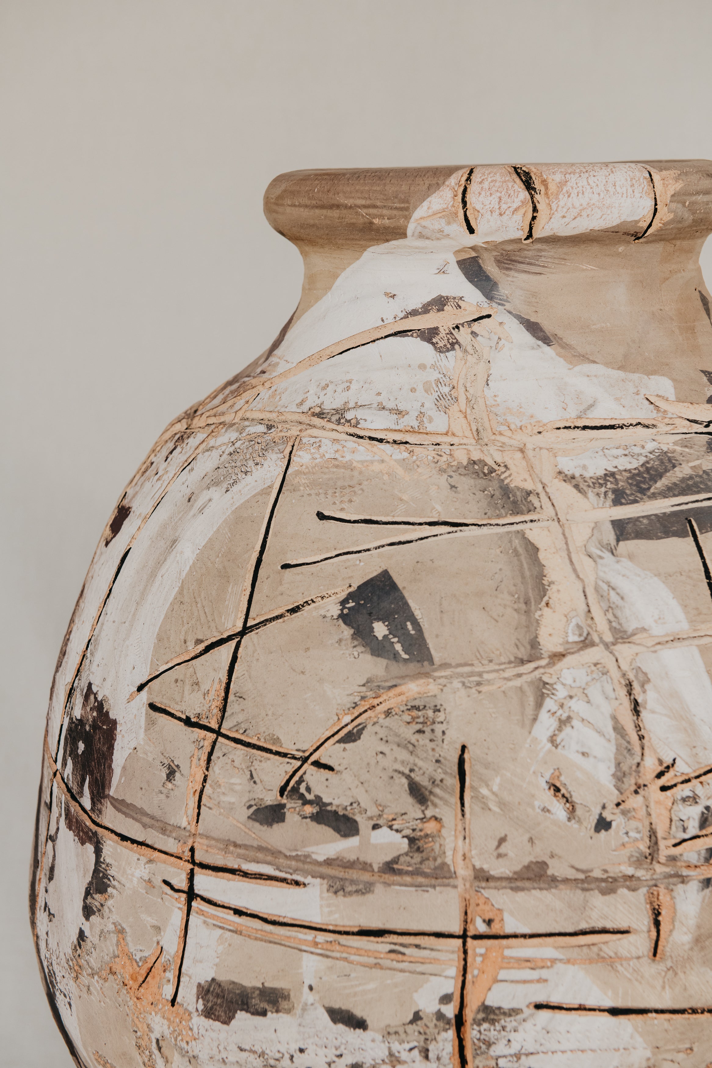 Vintage ceramic vase with decorative cracks on a plain background