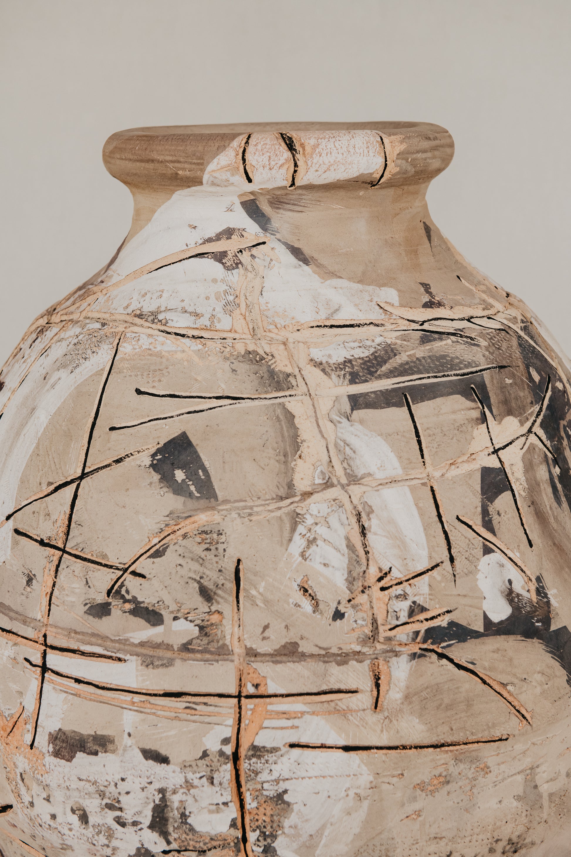 Ceramic vase with decorative cracks on a plain background