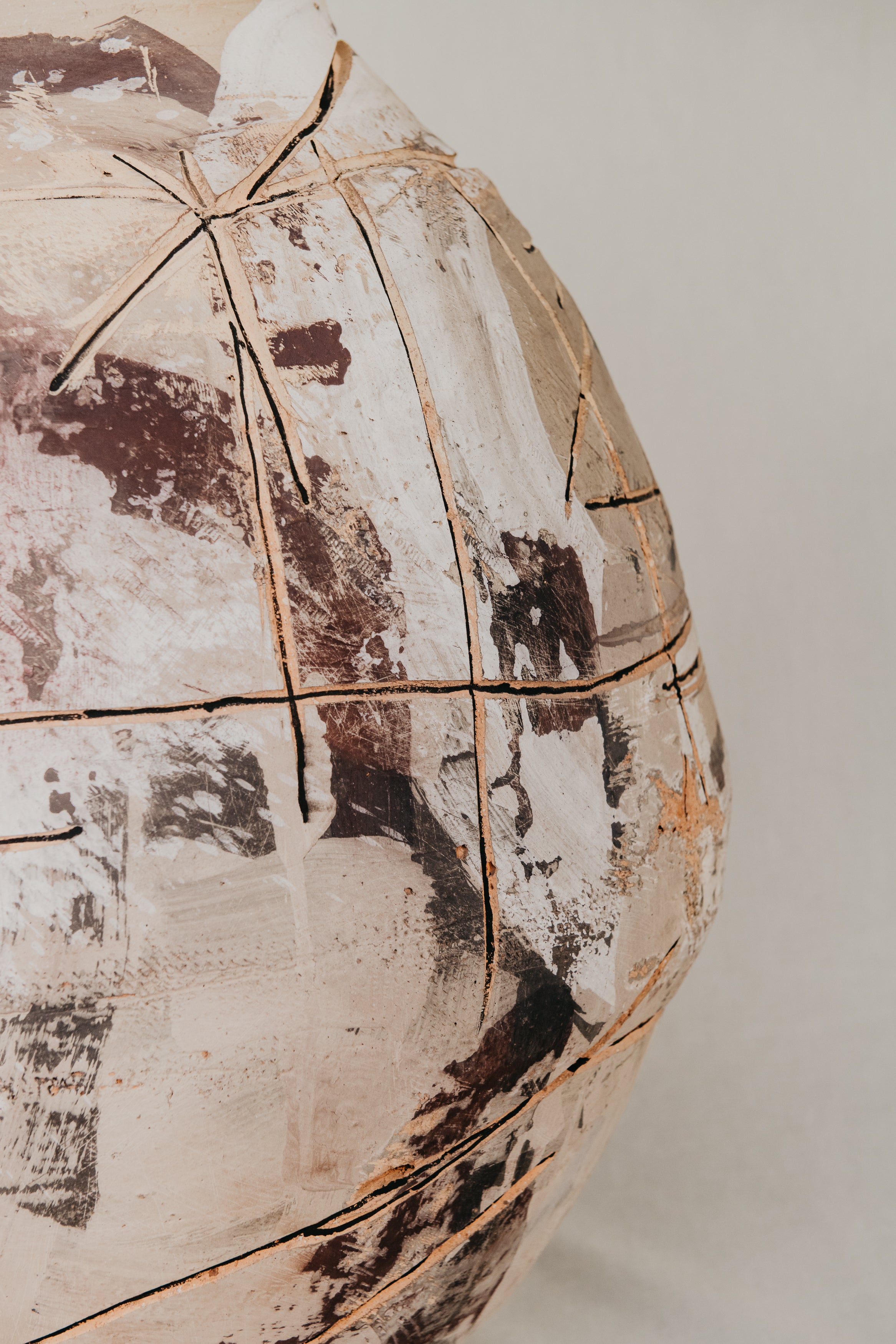 Vintage-style jacket with a distressed pattern on a mannequin against a plain background