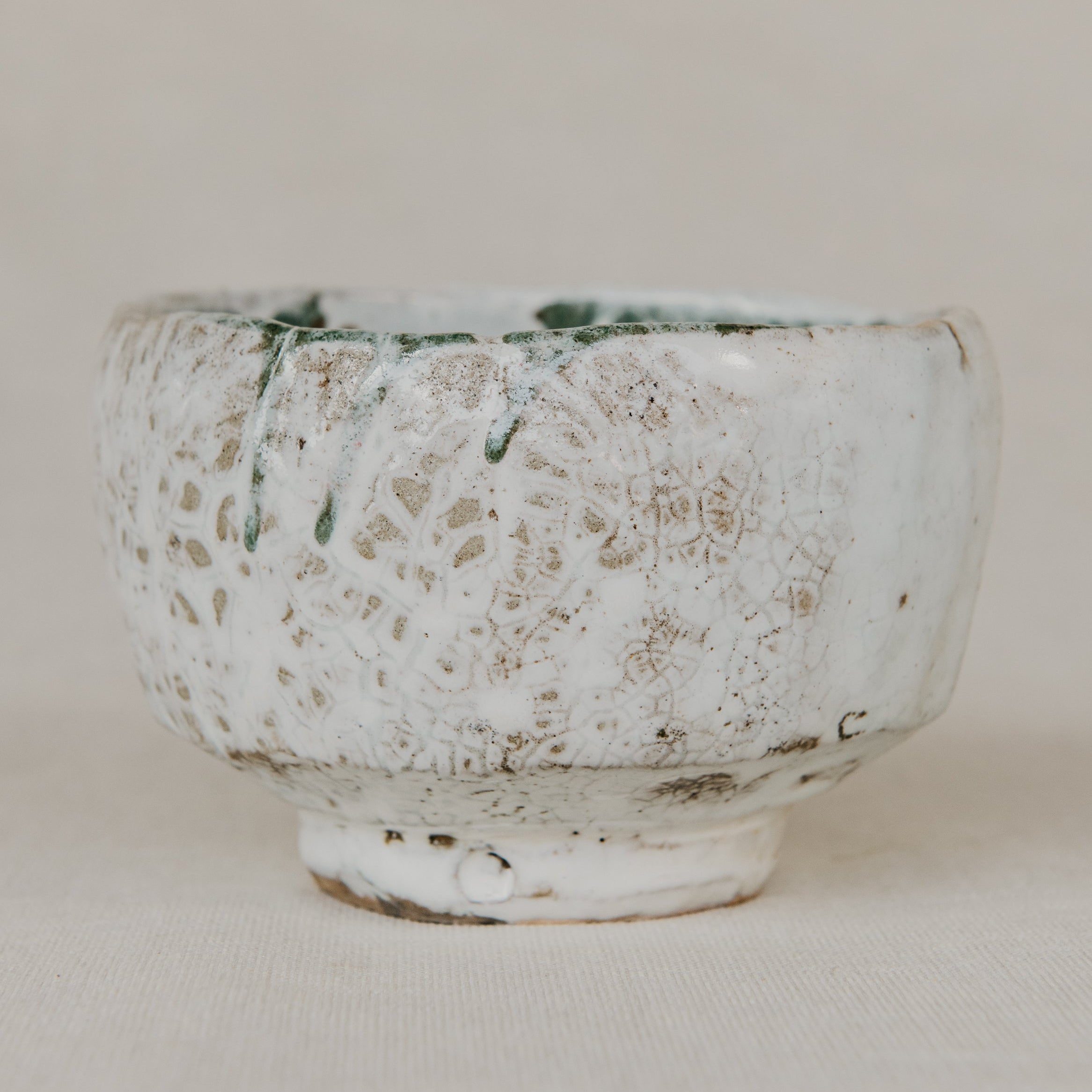 White ceramic bowl with textured surface on a plain background
