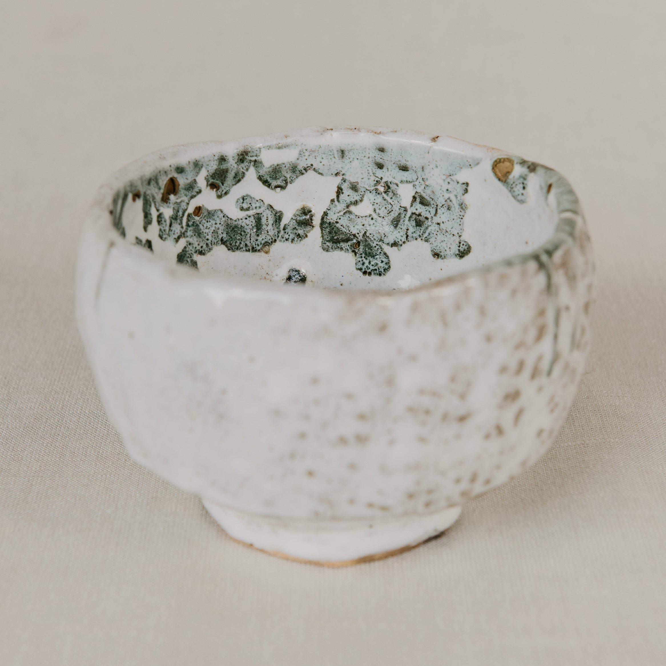 Ceramic bowl with textured surface on a beige background