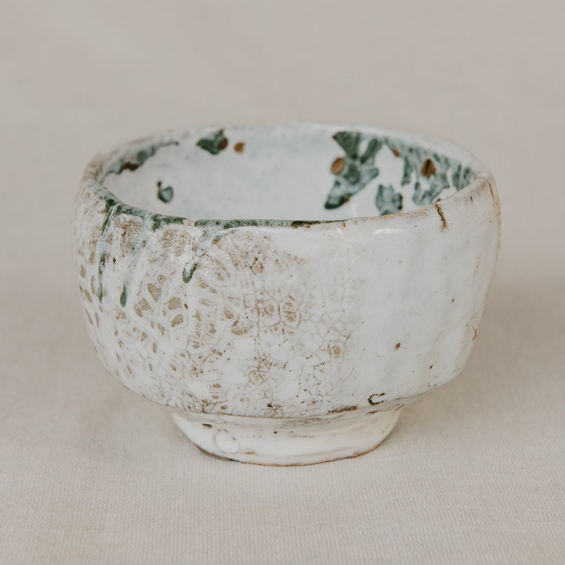 Ceramic bowl with textured surface on a beige background