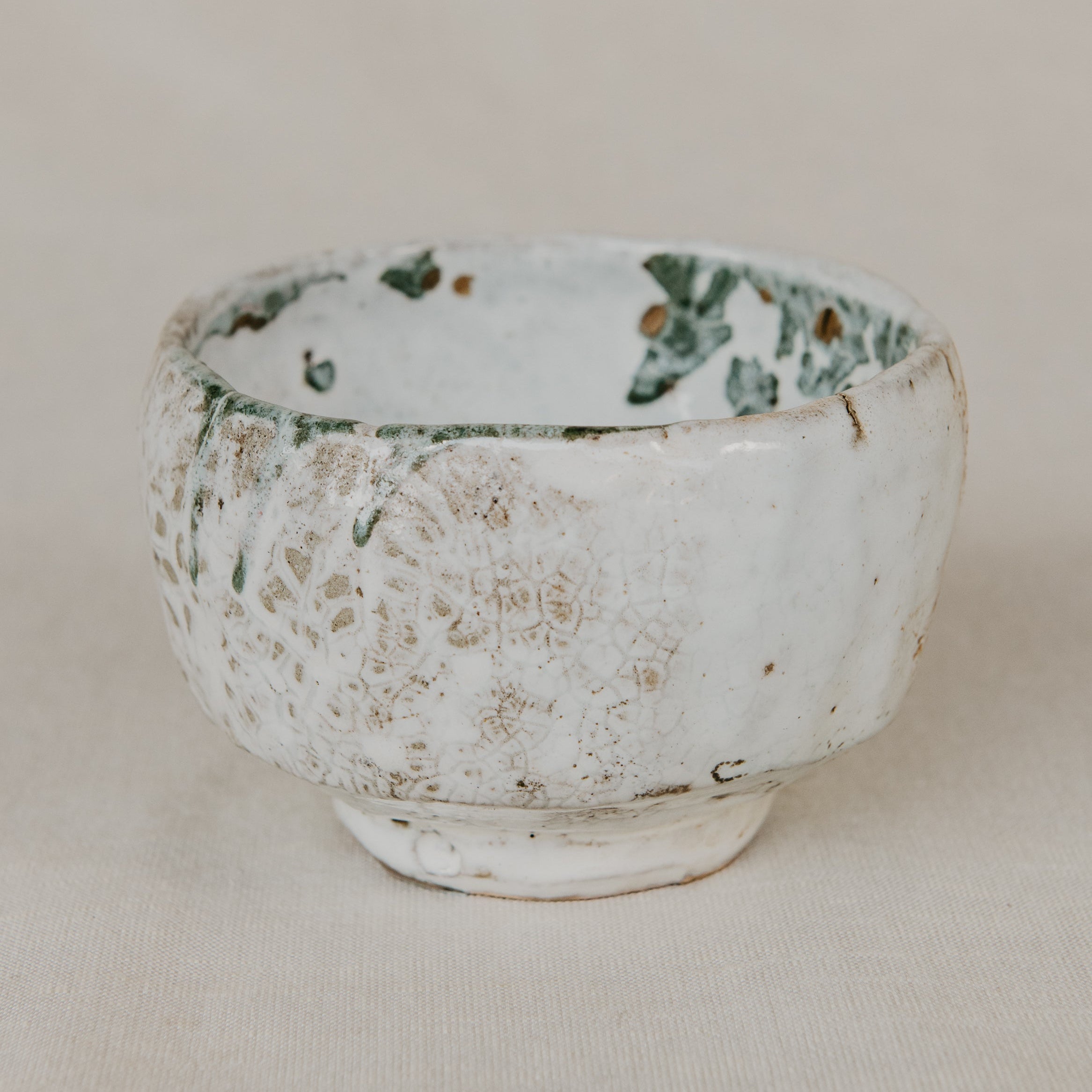 Ceramic bowl with textured surface on a beige background
