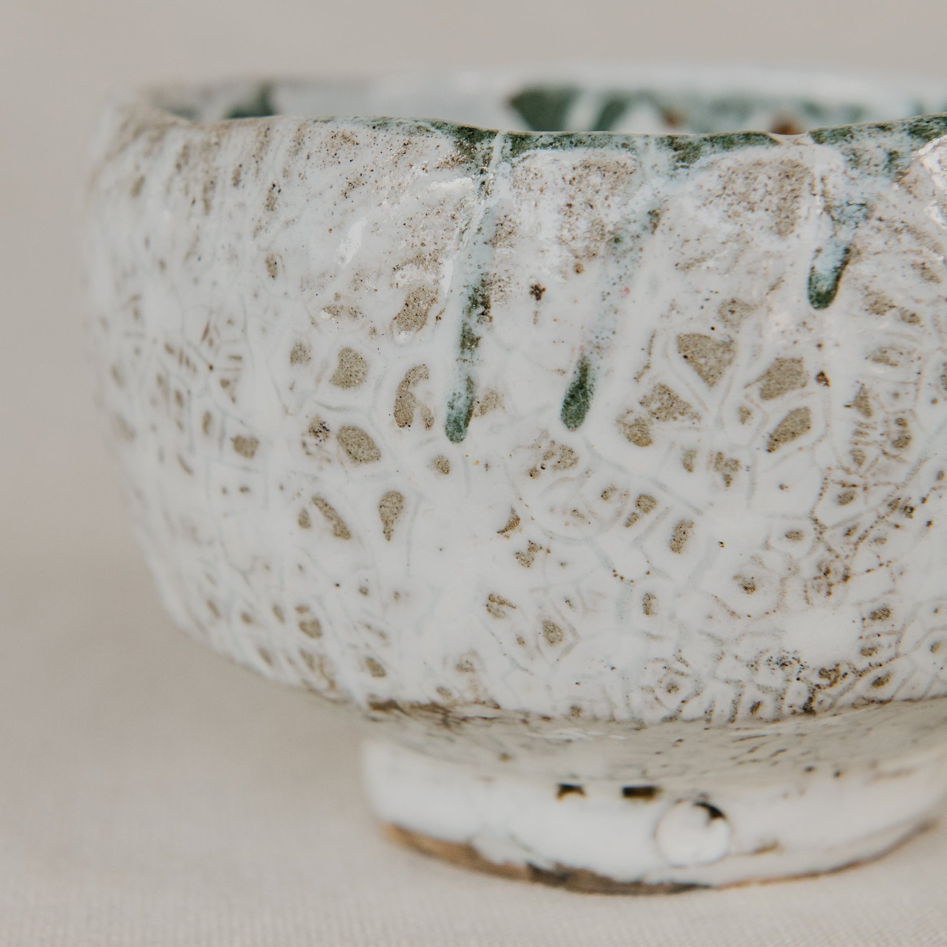Ceramic bowl with textured surface on a plain background
