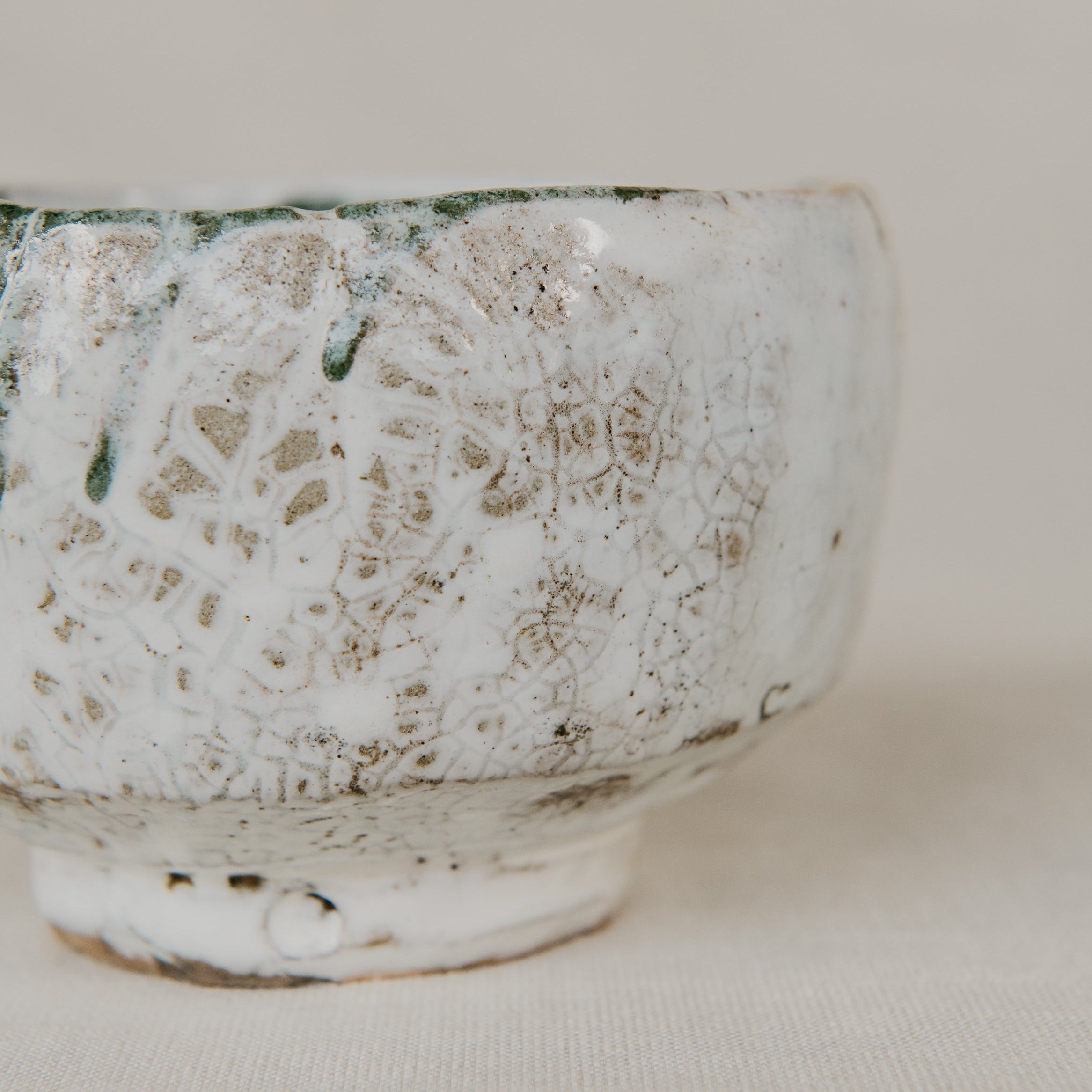 Ceramic cup with textured surface on a plain background