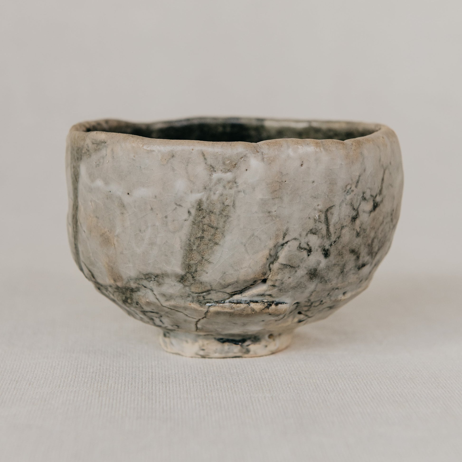 Small ceramic bowl with textured surface on a plain background