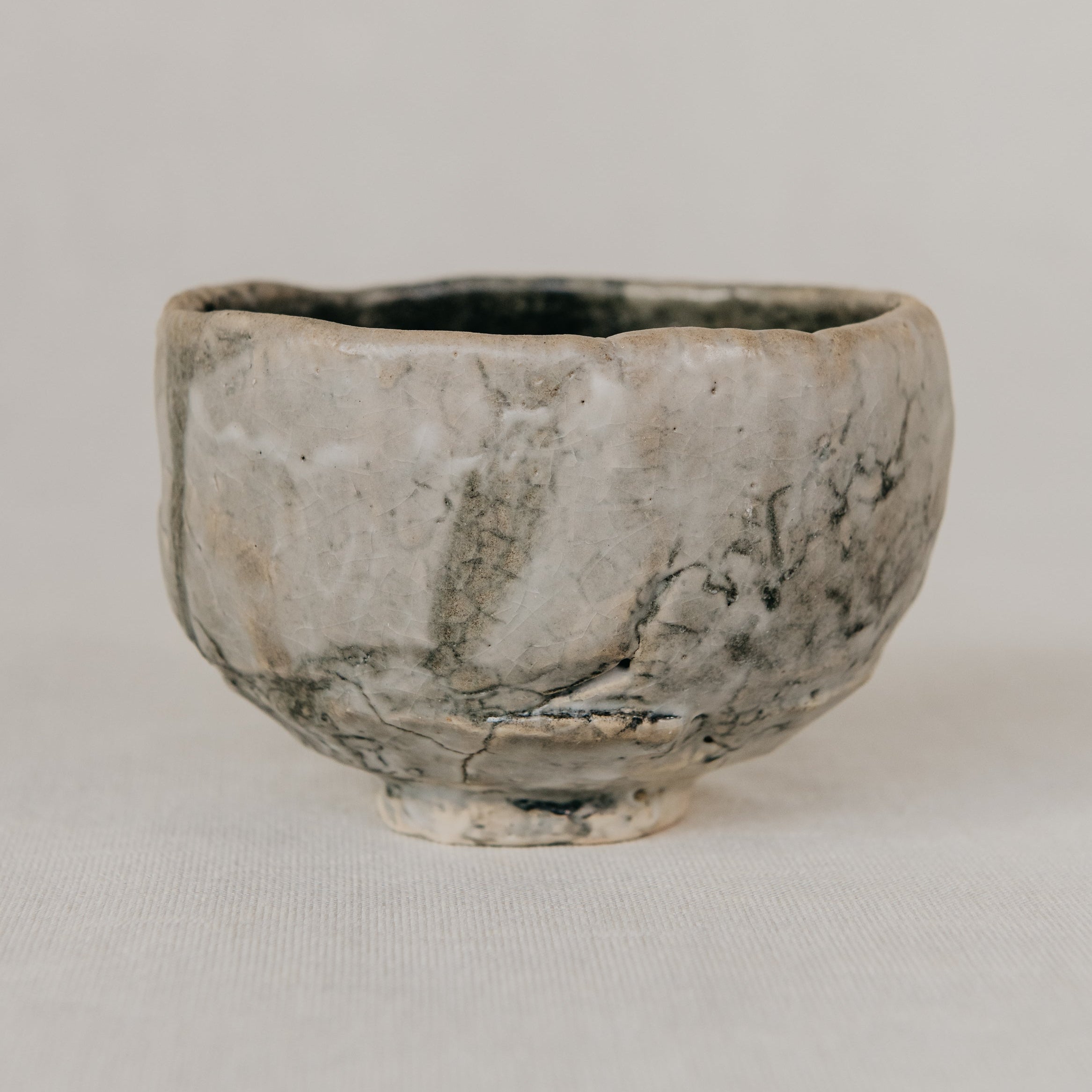Small ceramic bowl with textured surface on a plain background