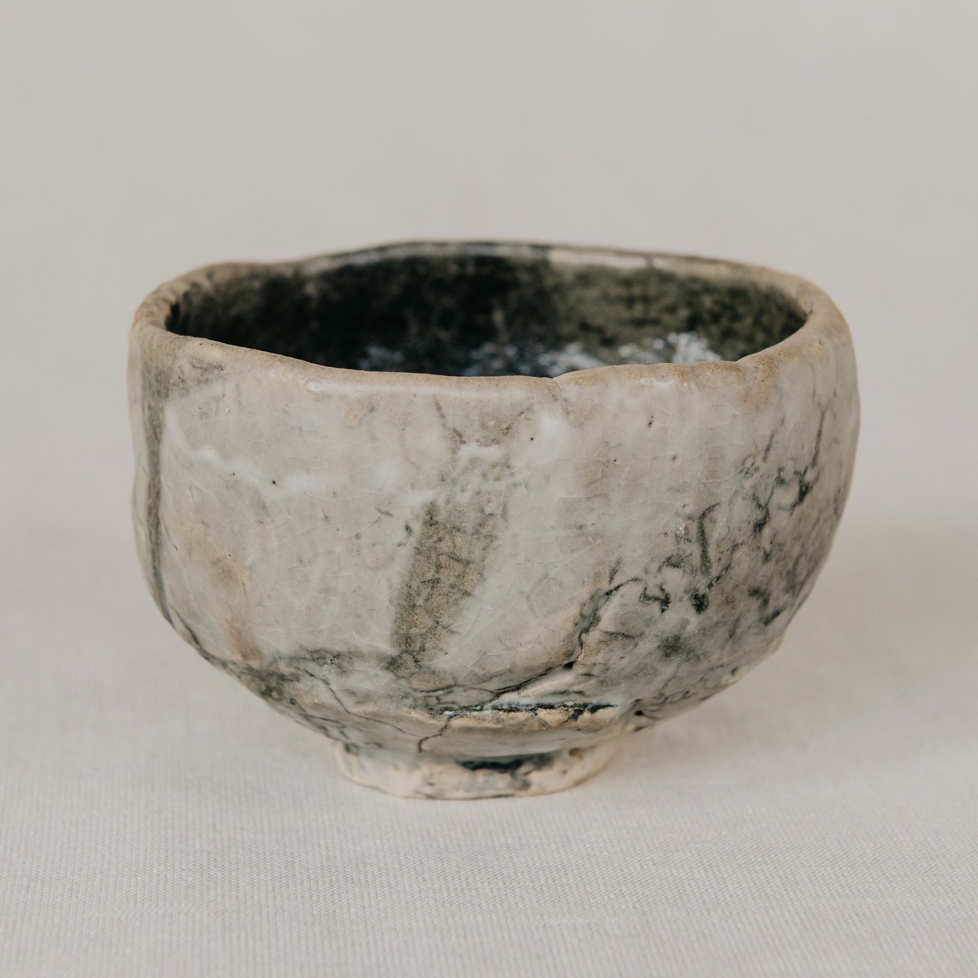 Small ceramic bowl with a textured surface on a plain background