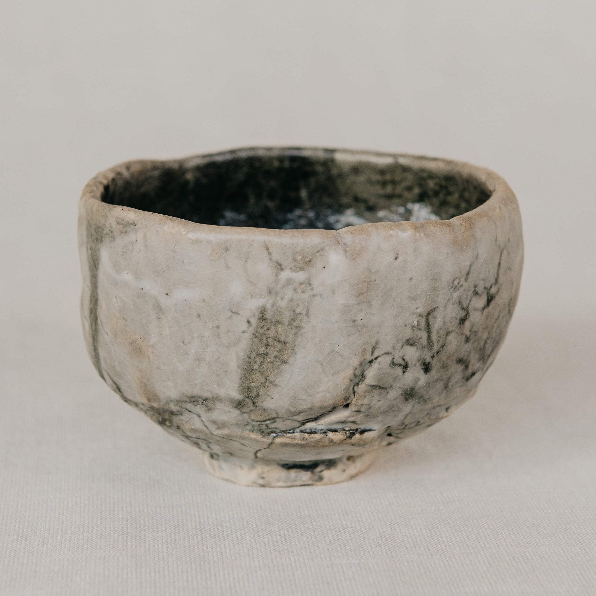 Small ceramic bowl with a textured surface on a plain background