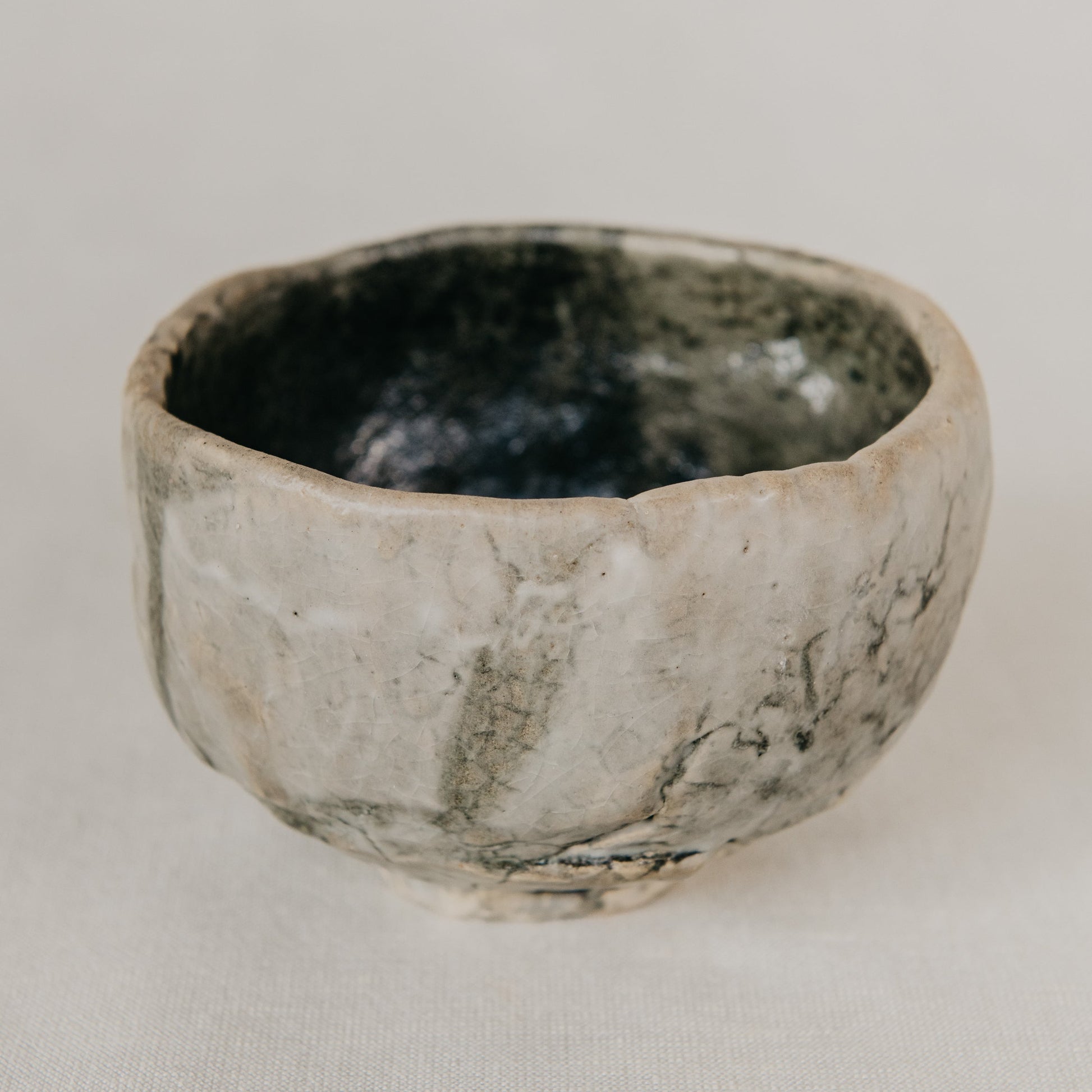 Small ceramic bowl with a textured surface on a plain background