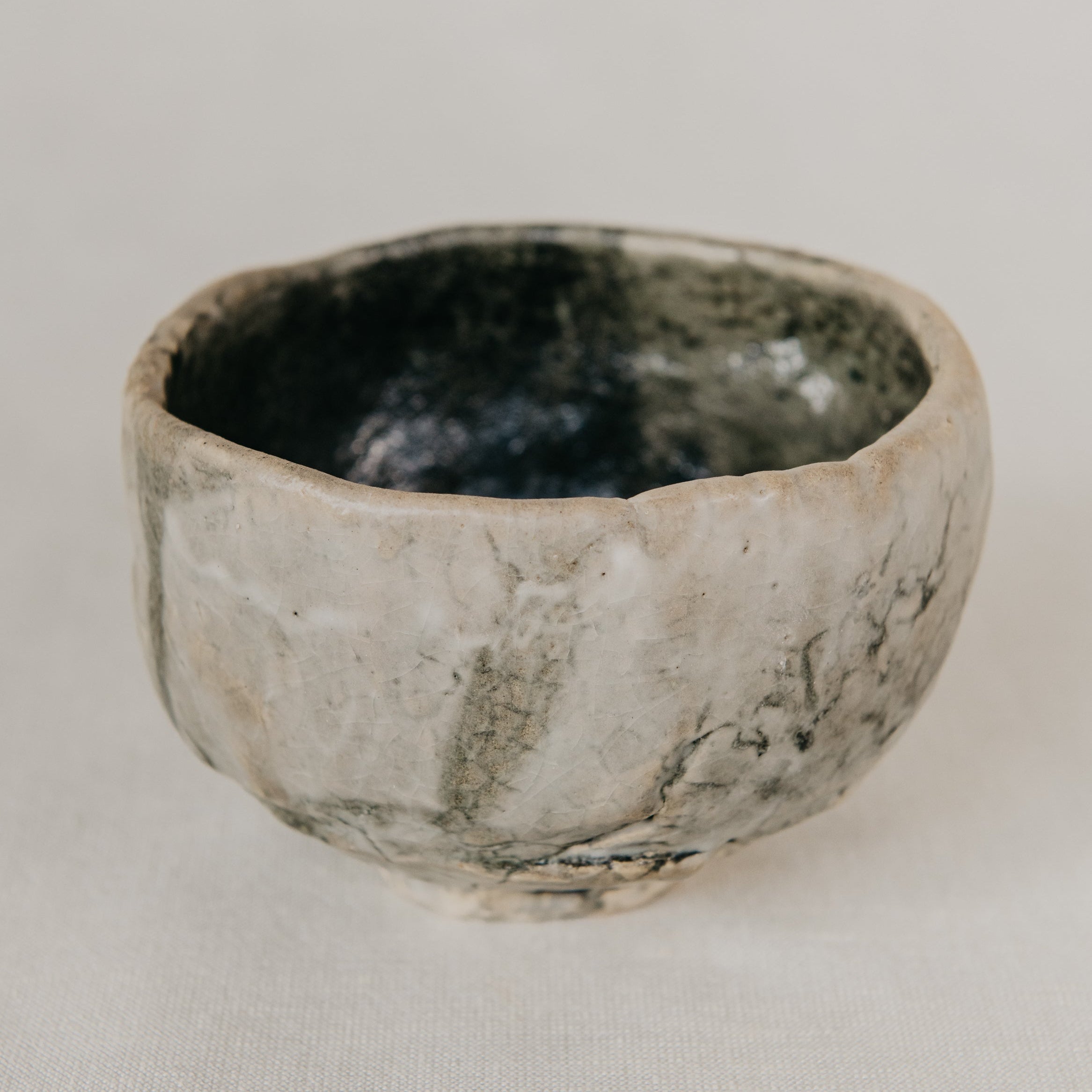 Small ceramic bowl with a textured surface on a plain background