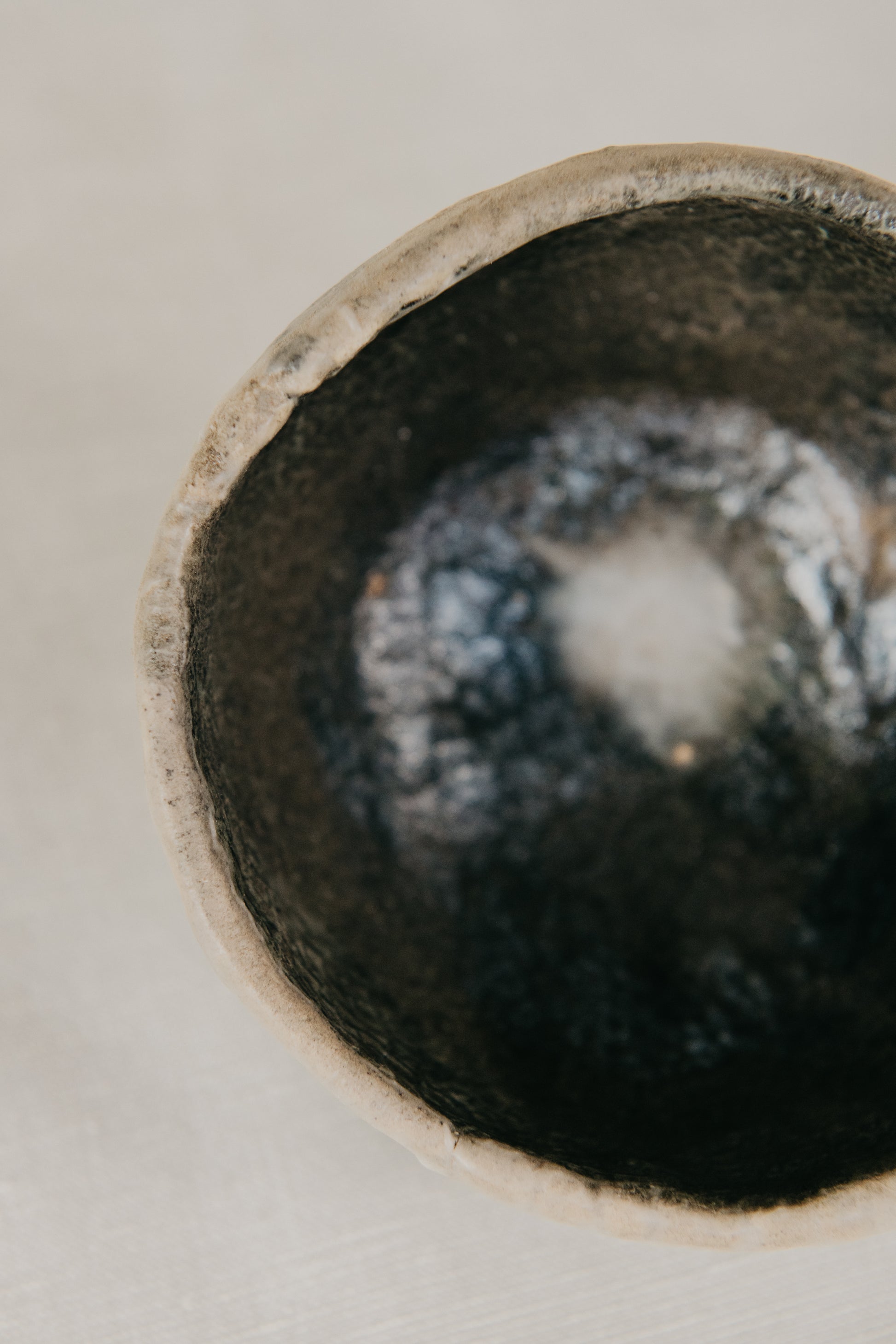 Close-up of a ceramic bowl with a textured interior on a light background
