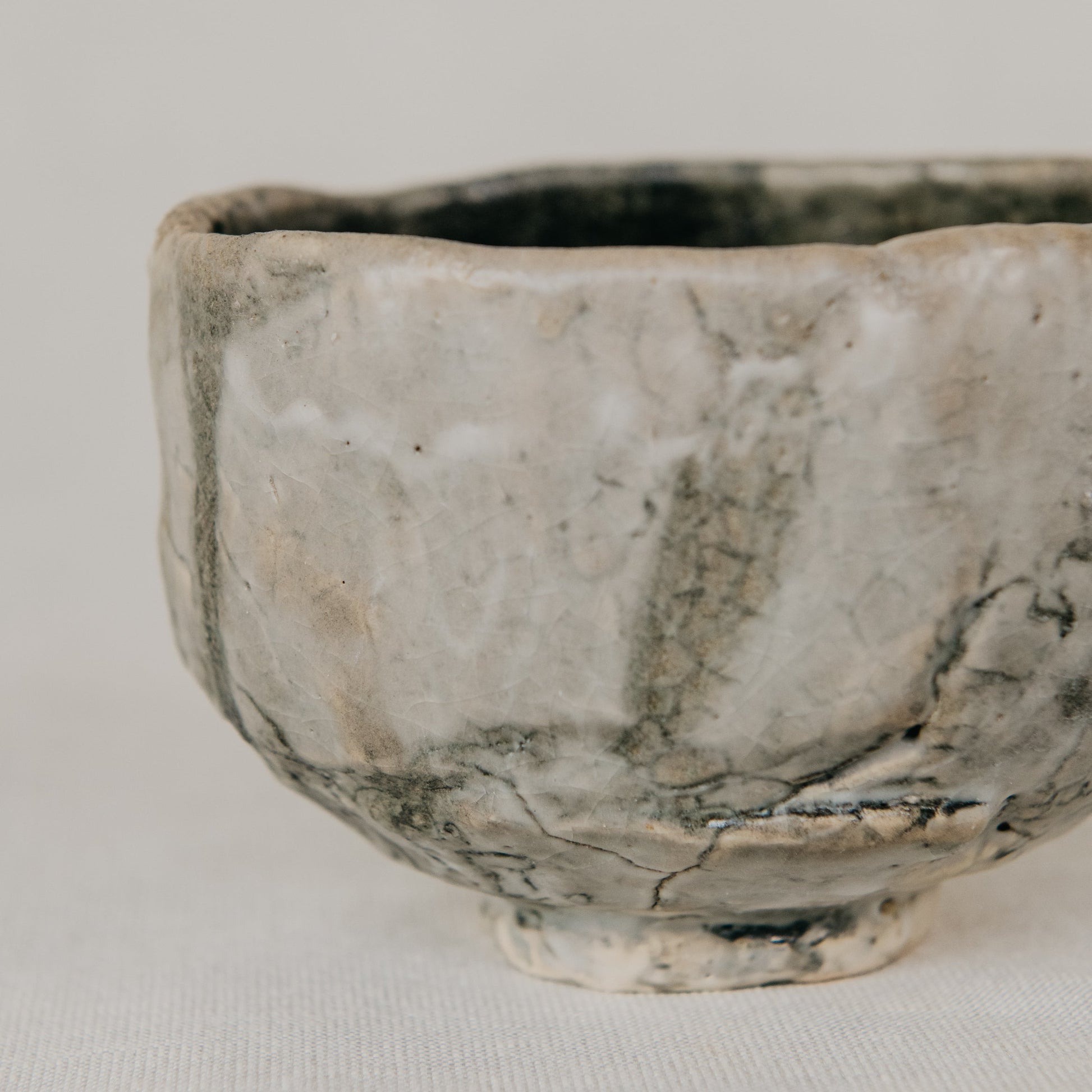 Small ceramic bowl with a textured surface on a plain background