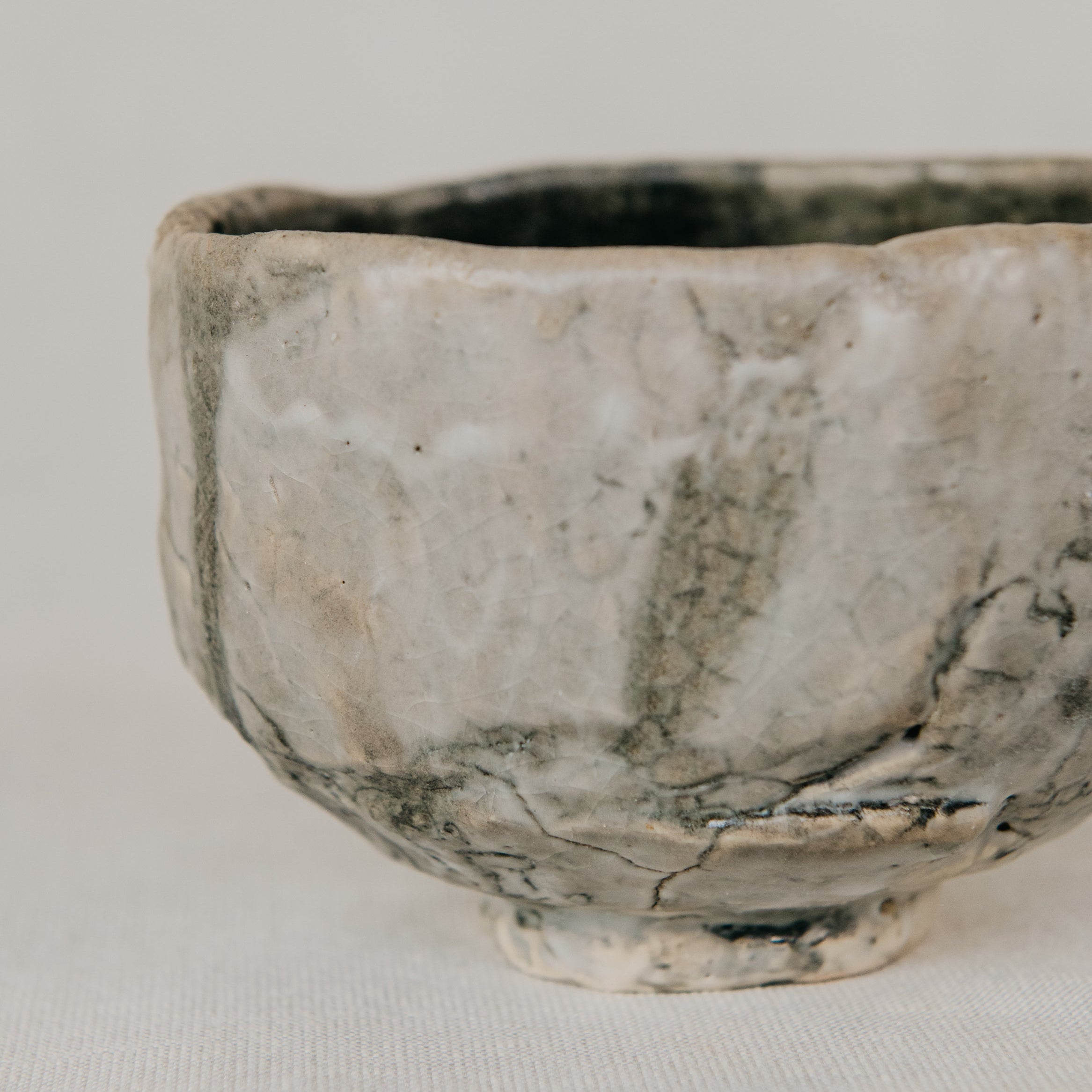 Small ceramic bowl with a textured surface on a plain background