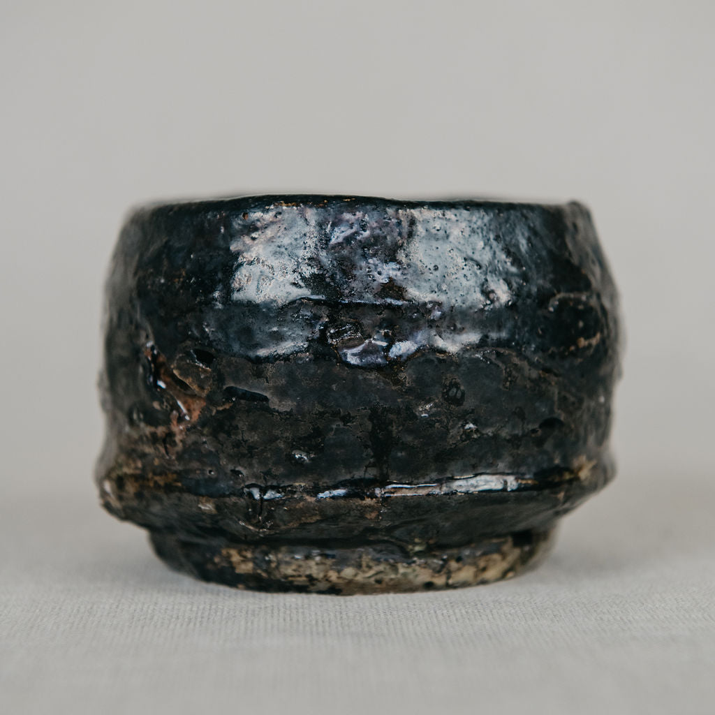 Black ceramic bowl on a gray background