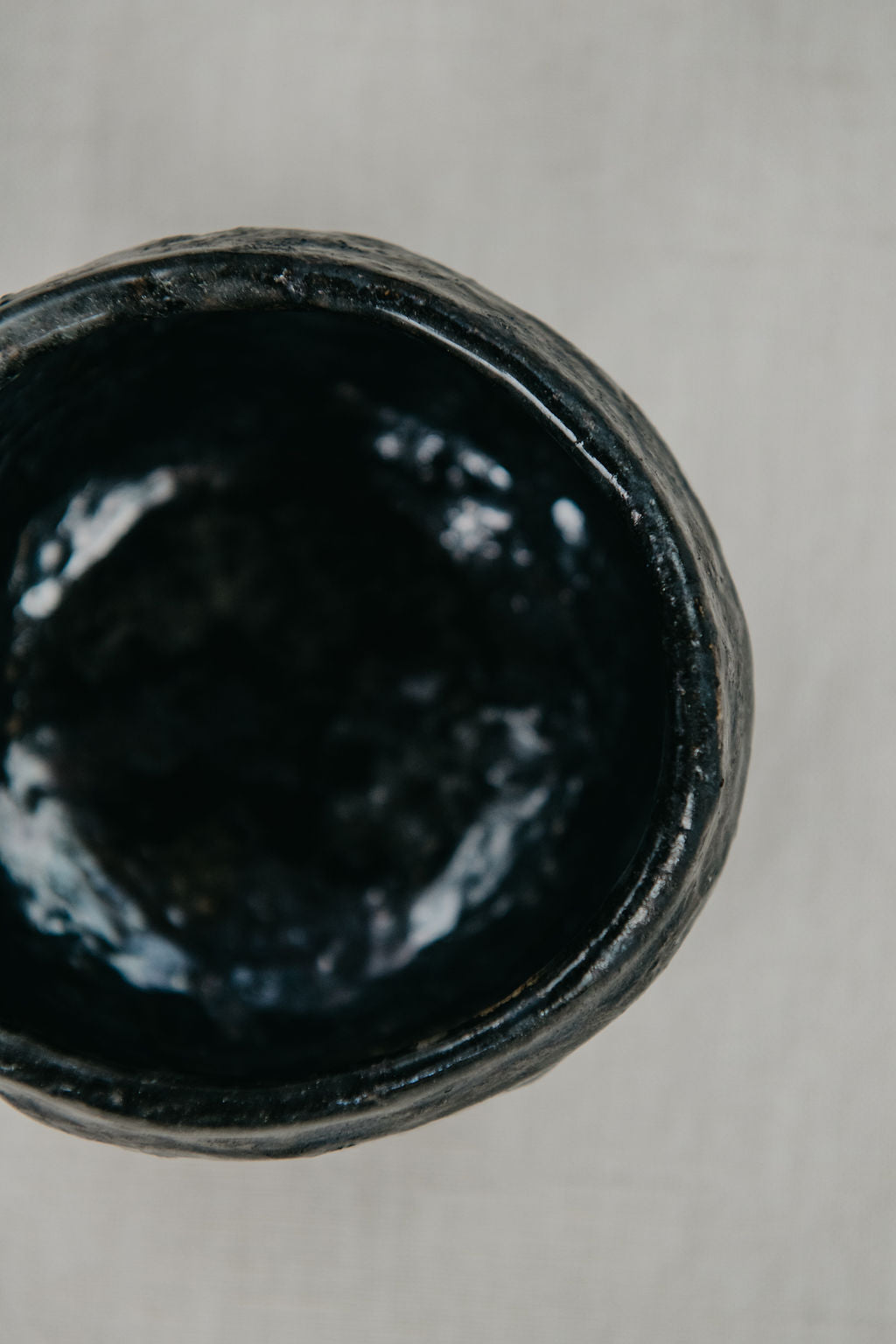 Close-up of a black ceramic bowl on a gray background