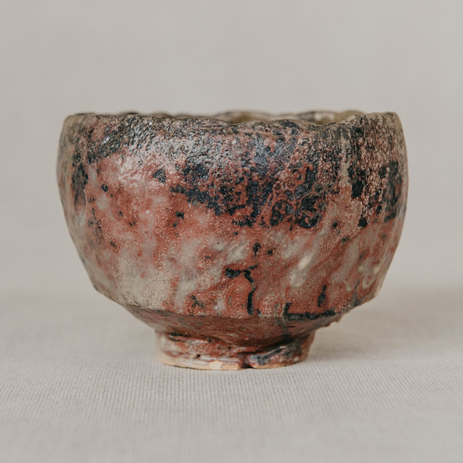 Ceramic cup with a textured surface on a plain background