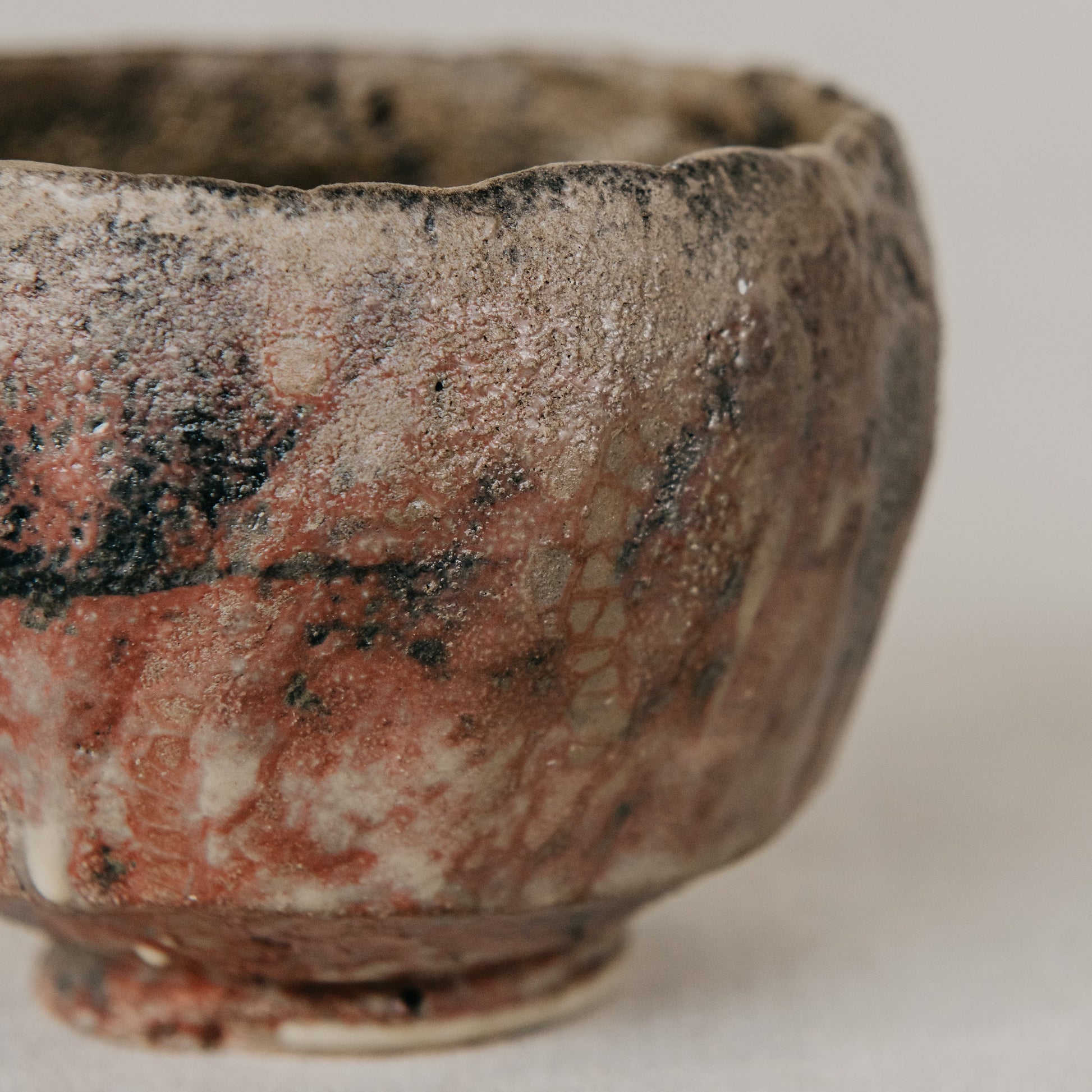 Close-up of a ceramic bowl with textured surface on a light background