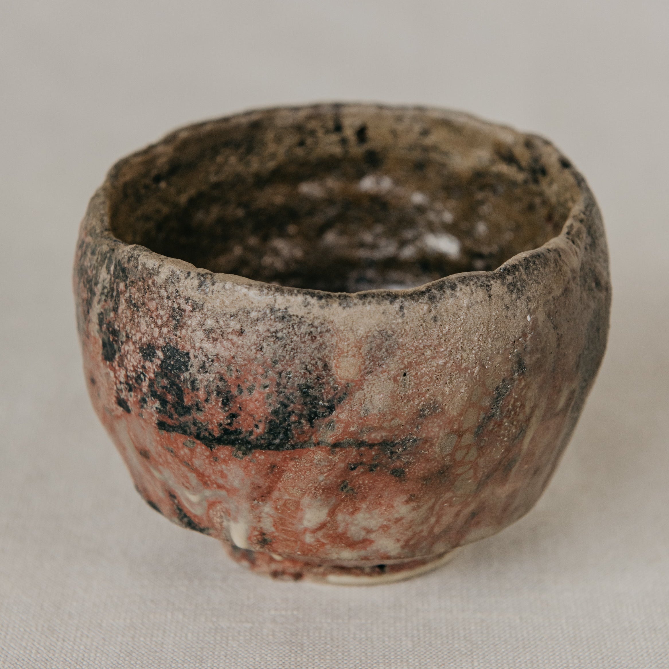 Small ceramic bowl with a textured surface on a plain background