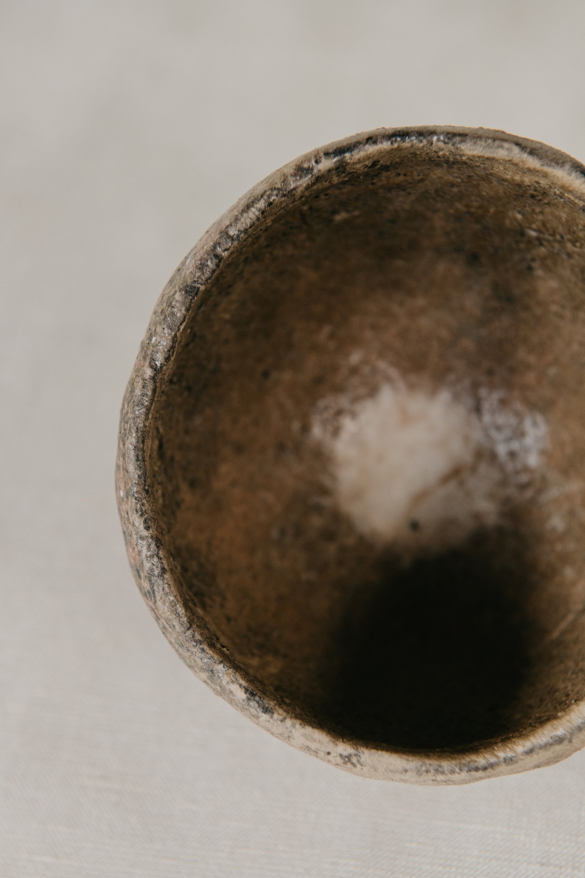 Close-up of a textured ceramic bowl on a neutral background