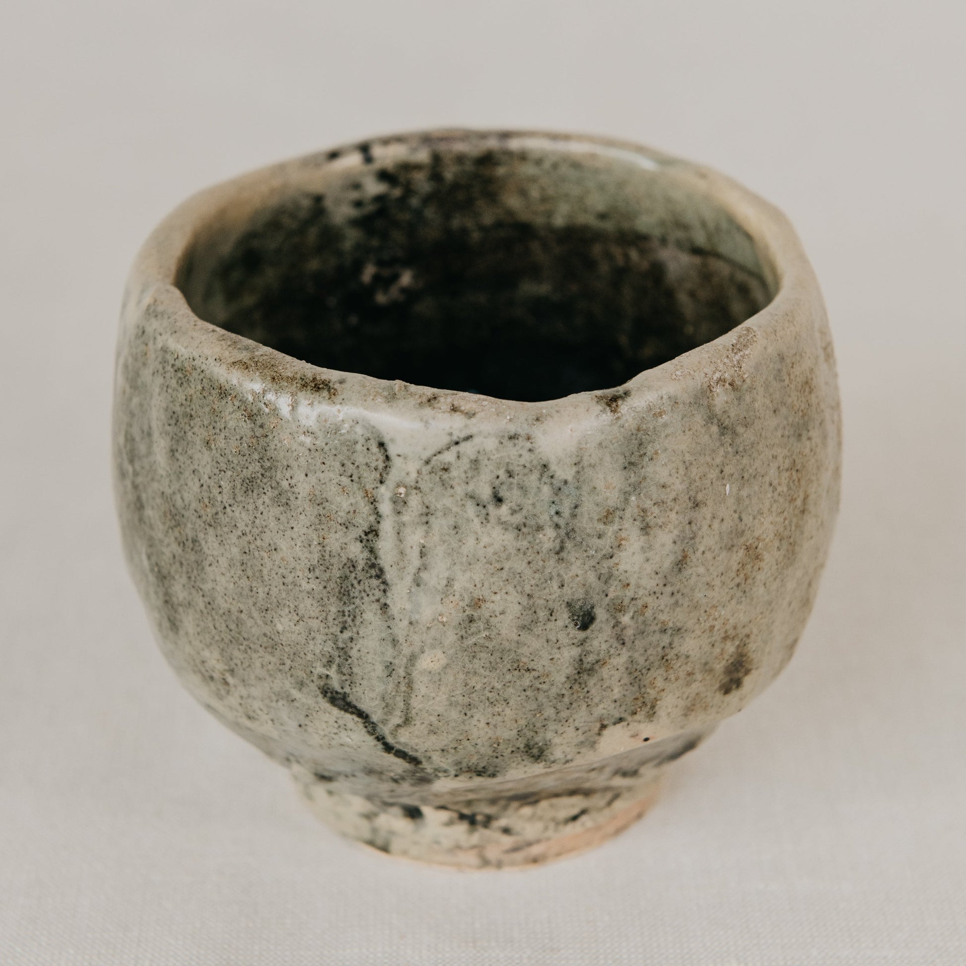 Ceramic cup with textured surface on a plain background