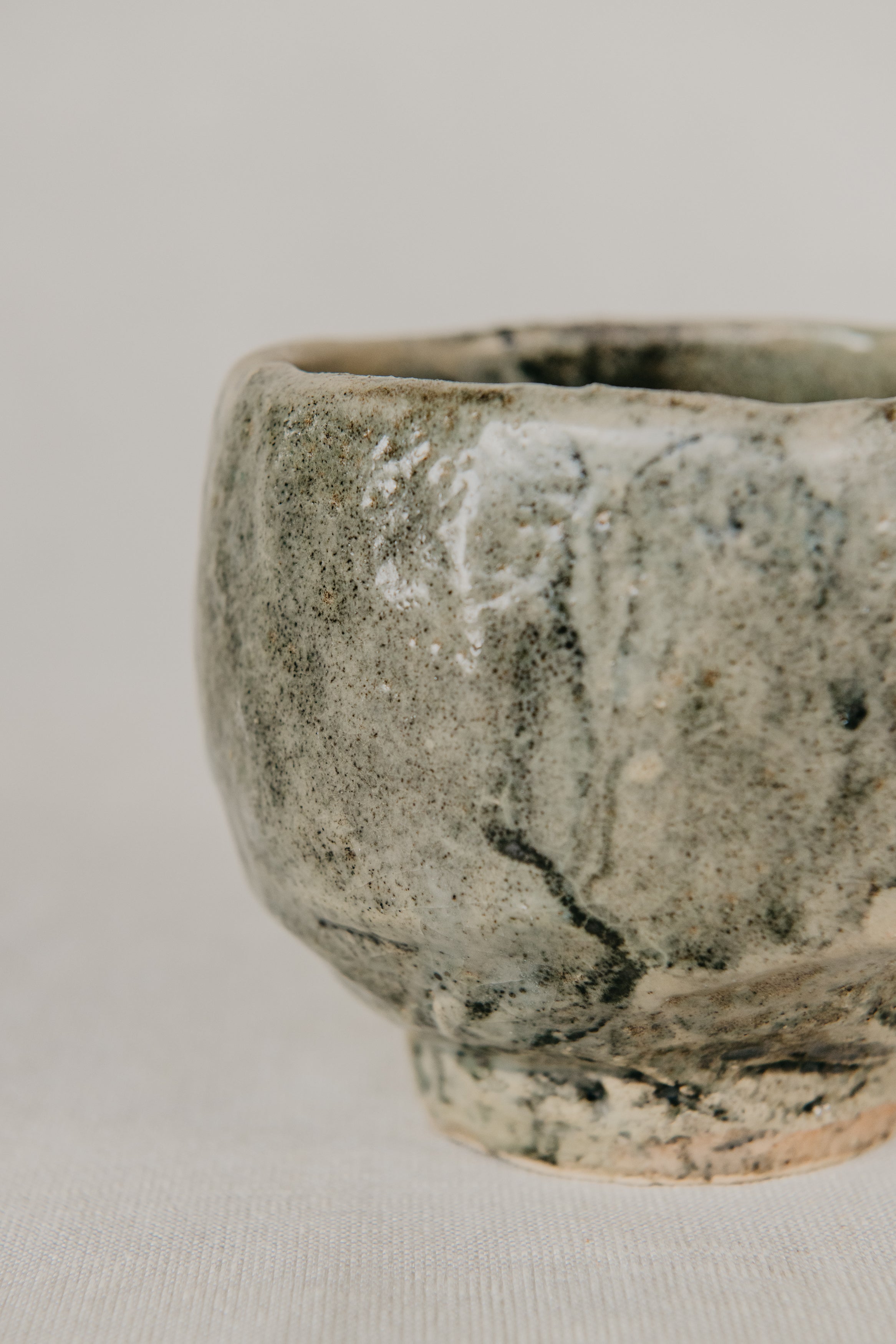 Ceramic cup with a textured surface on a plain background
