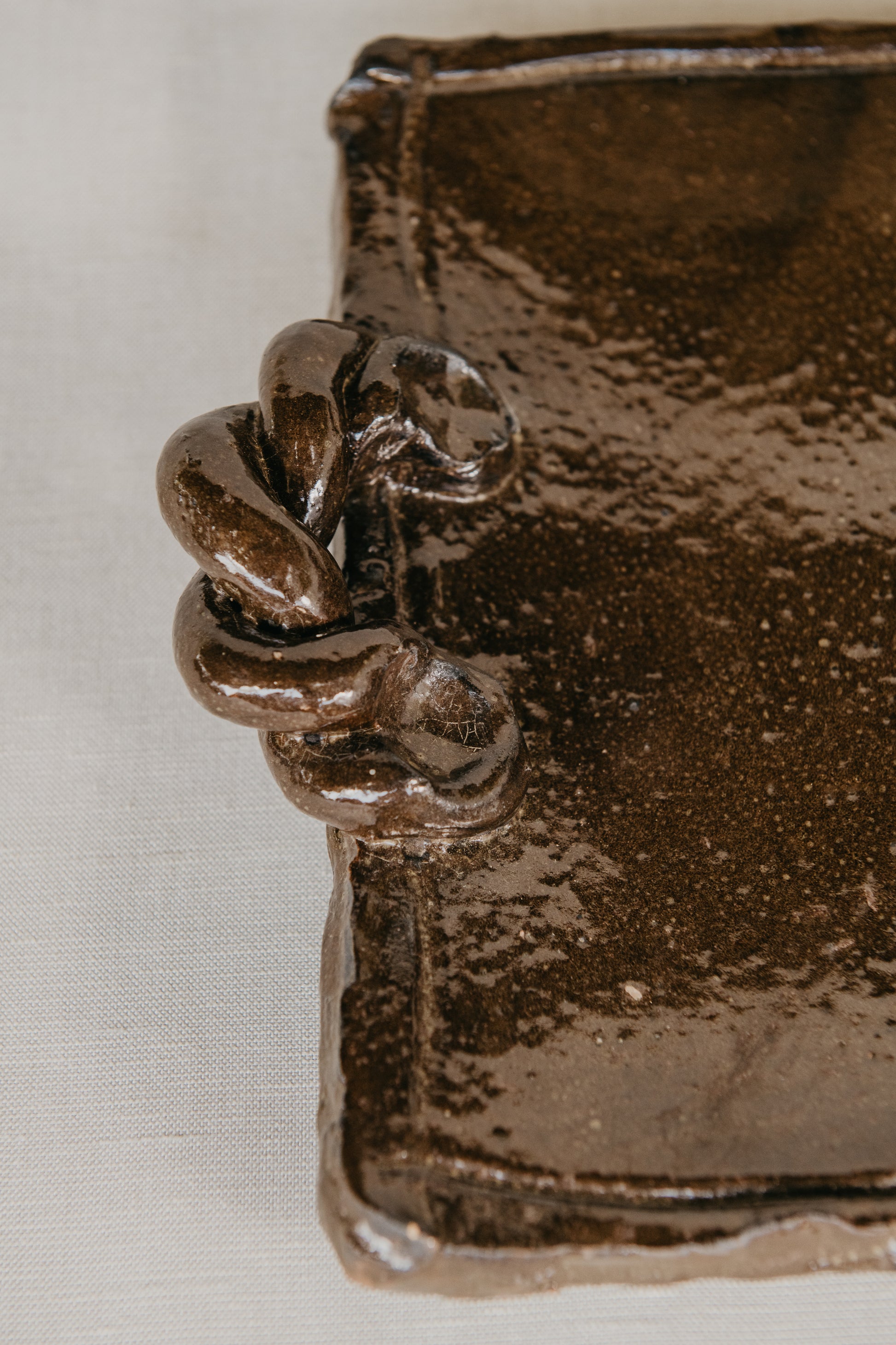 Close-up of a bronze decorative element on a textured surface
