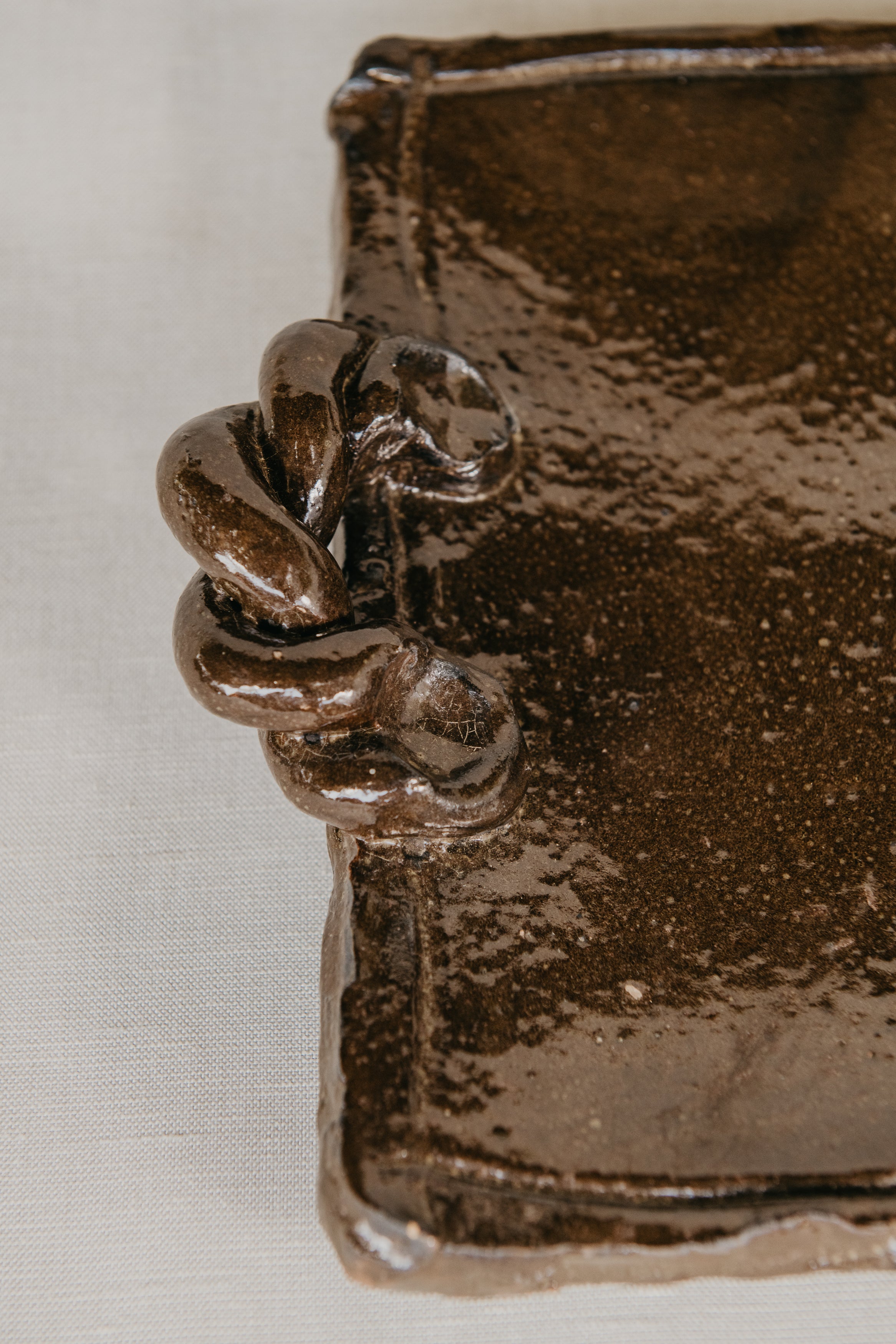 Close-up of a bronze decorative element on a textured surface