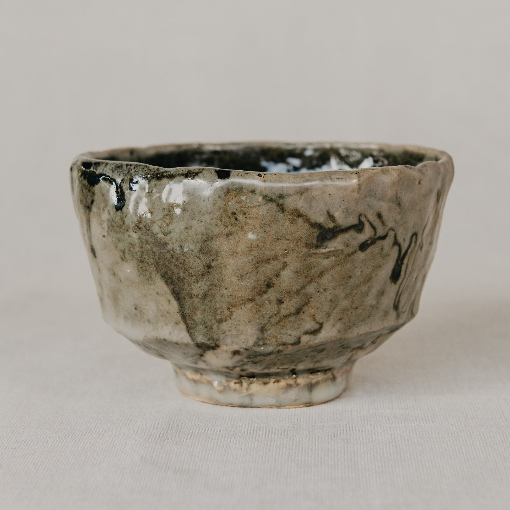 Small ceramic bowl with a textured surface on a plain background