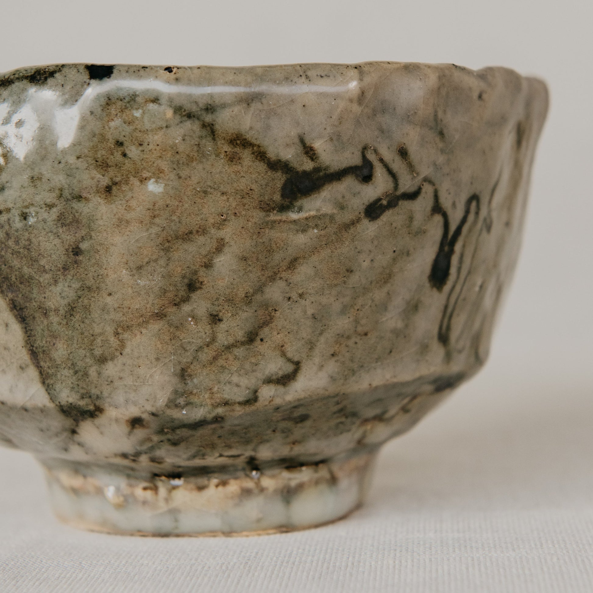 Vintage ceramic bowl with black abstract design on a white background