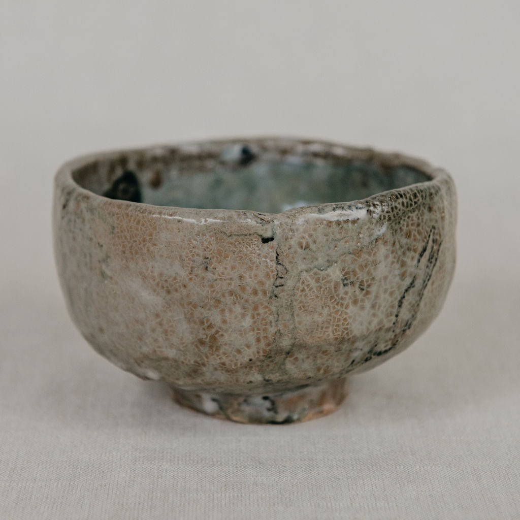 Ceramic cup with a textured surface on a plain background